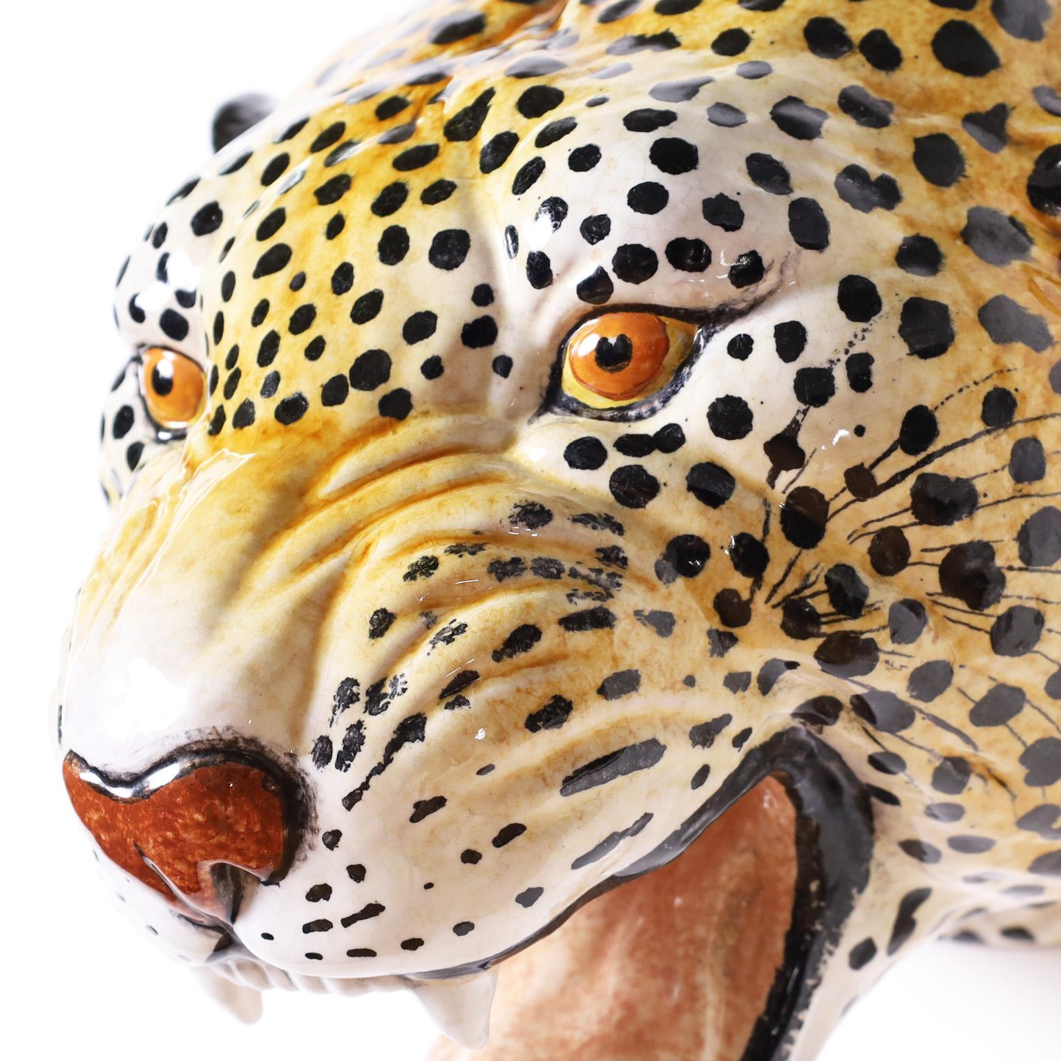 One of mother nature's most iconic designs, the big cat. Here we present a terra cotta wall mounted head decorated and glazed, a leopard depicted with amazing accuracy.
