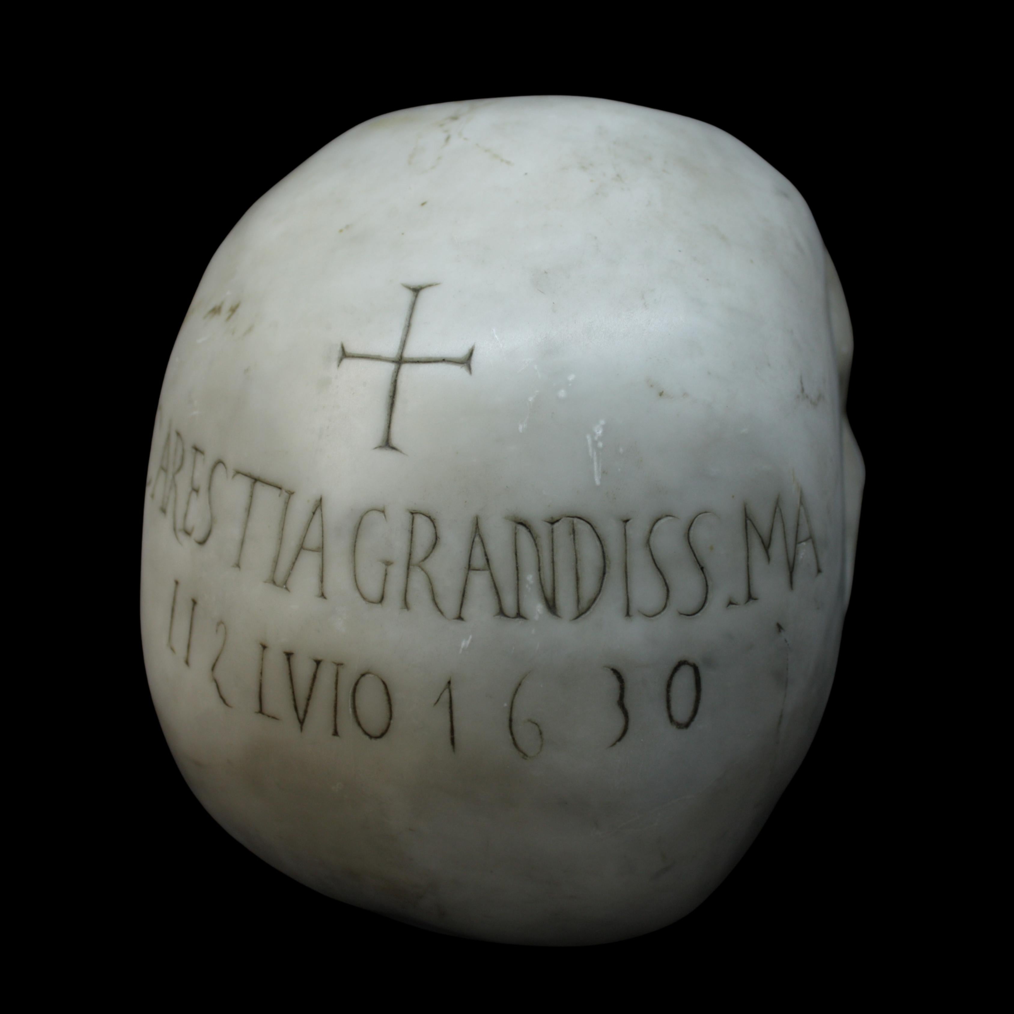 Evocative and rare 17th-century carved marble skull from Lombardy, Italy. The work bears an engraved inscription on the back that reads 