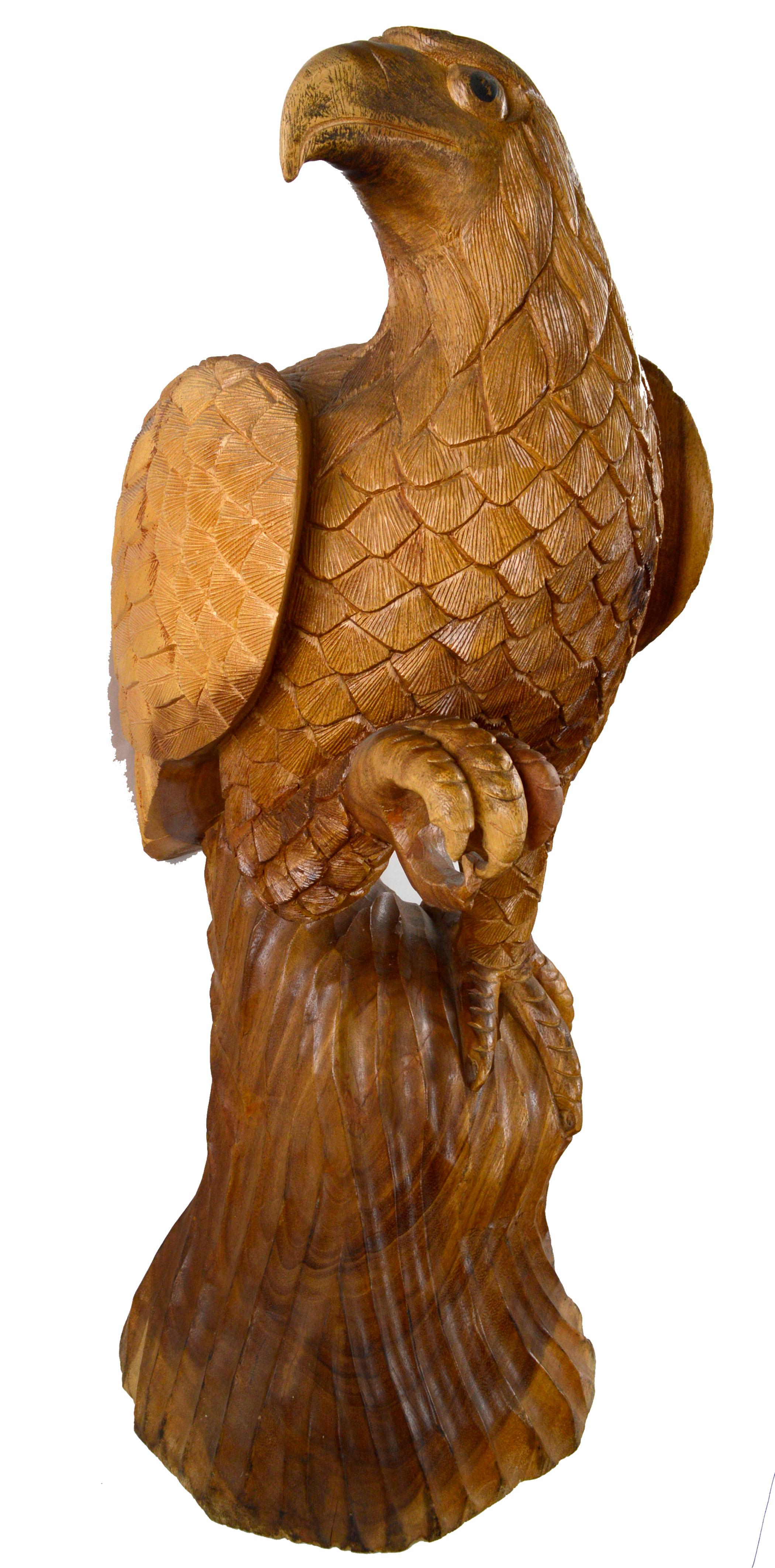 Hand carved solid wood sculpture of a perched eagle by an unknown artist, possibly a Bahamian local carver, c.1960s. Exquisite attention to detail and an elegant, subtle pose. Unsigned. Measures 35.5