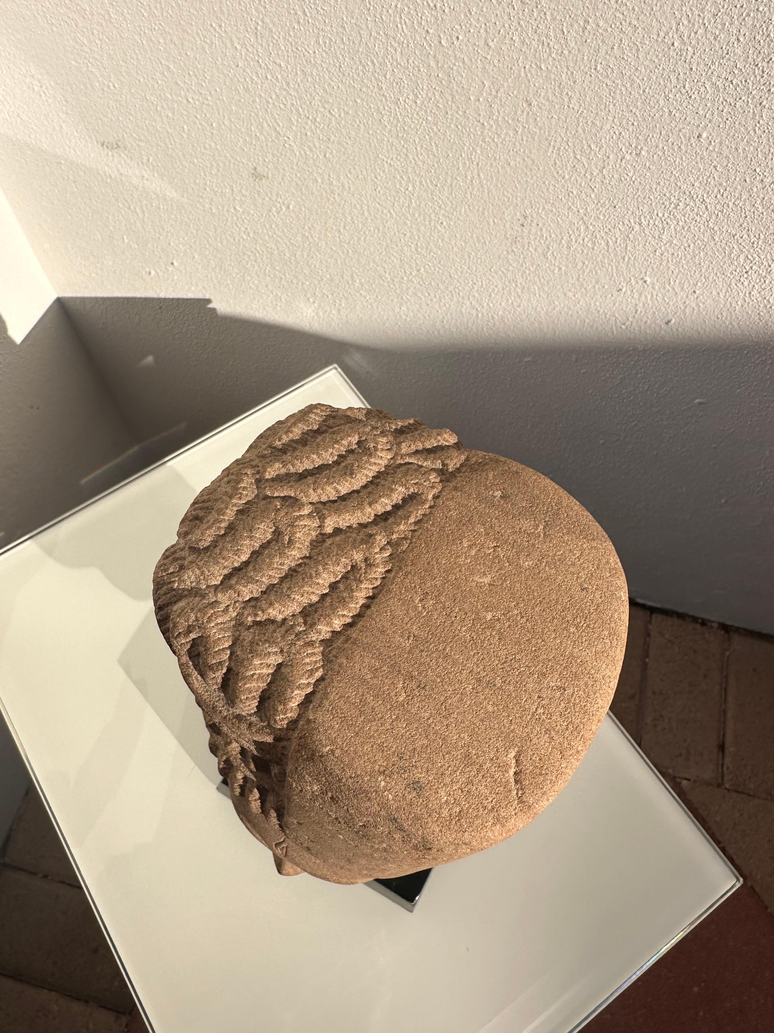 Beautiful 20th century reproduction of a 7th century Harihana. Carved sandstone. Measurements are with black stands. 

Syncretism is a favored device in Indian cosmologies for representing the complex and multifaceted personalities of the gods. The