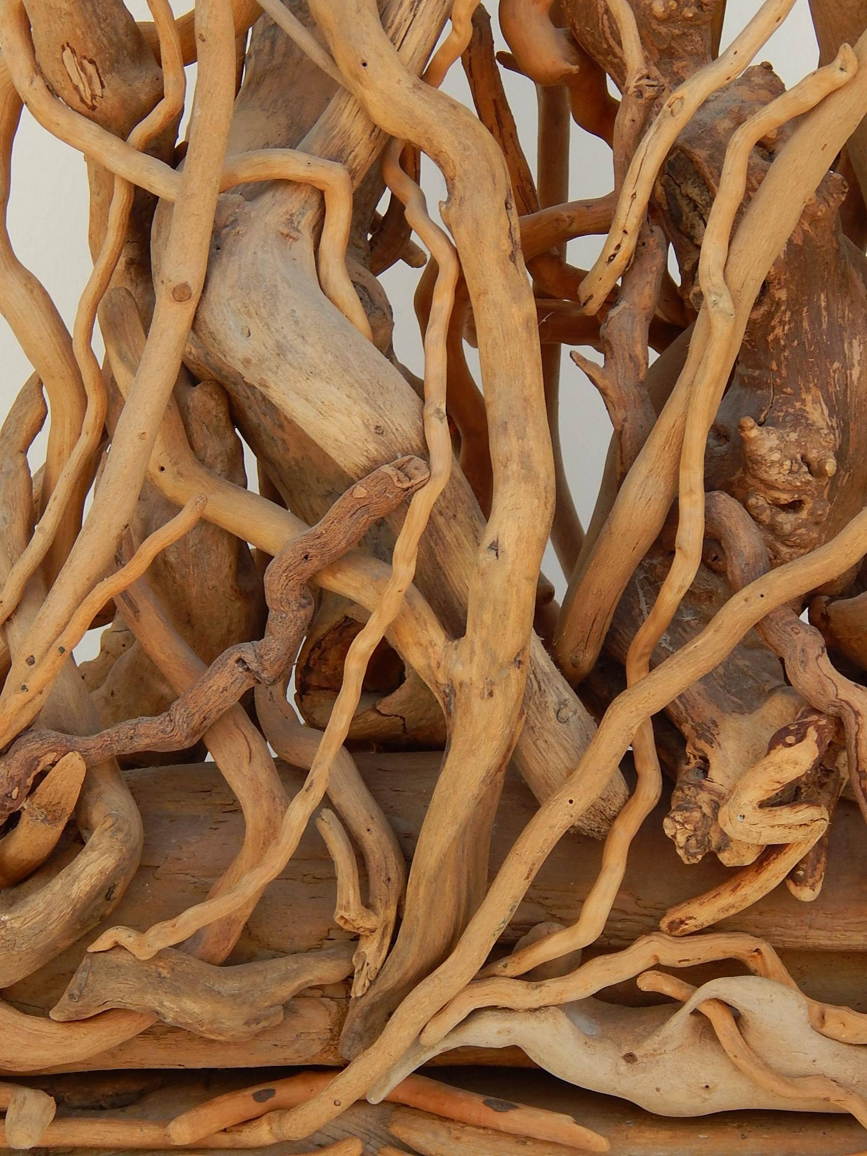 Accomplished artist Hubert Long created this striking display of found wood in 1977. 
He enjoyed some success with exhibitions at a gallery on Long Island in the 1960s and 1970s. 
The piece is signed “H. Long,” titled “JAS,” and dated 1977.