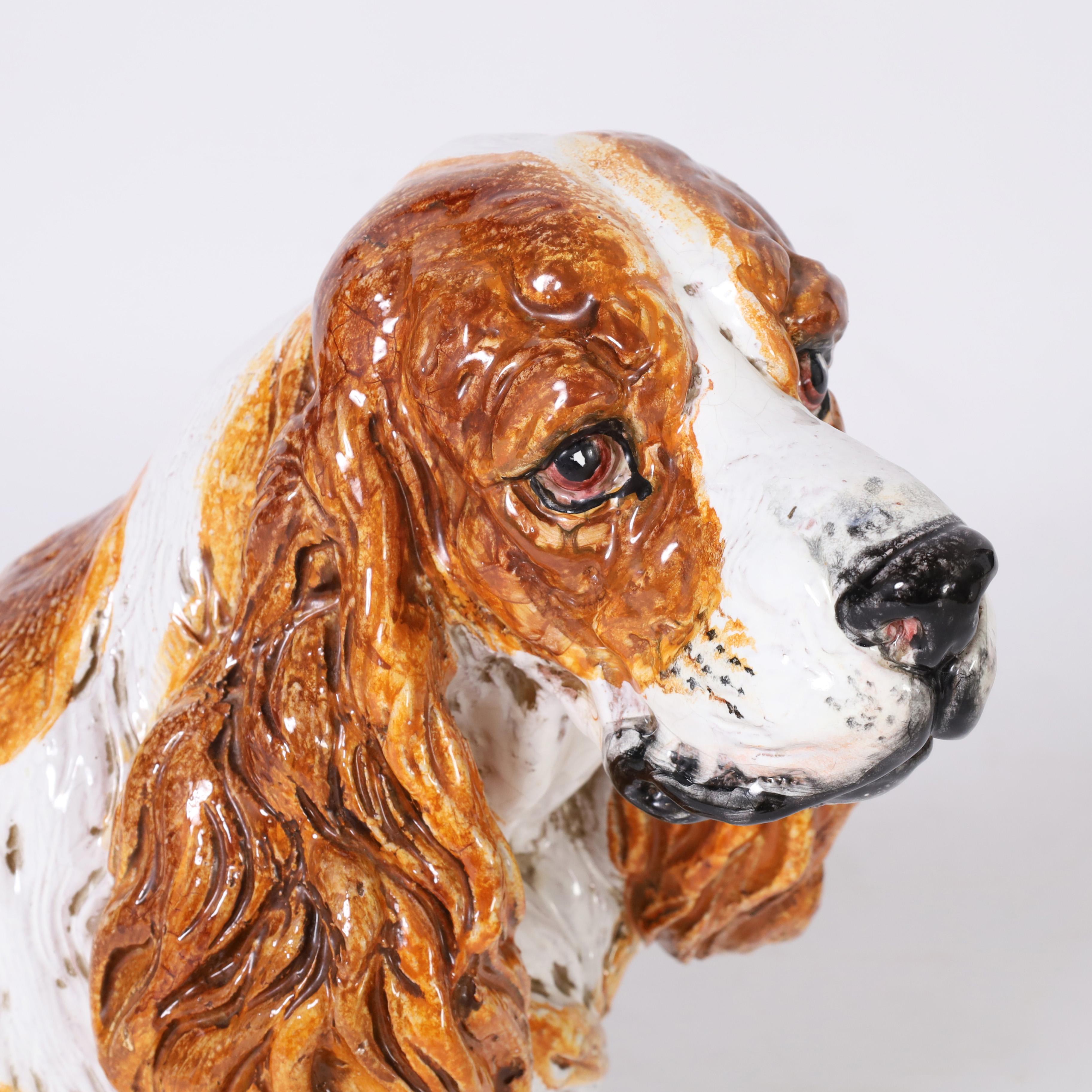 Charming Italian Cocker Spaniel sculpture crafted in terra cotta, hand decorated and glazed, complete with soulful expression.