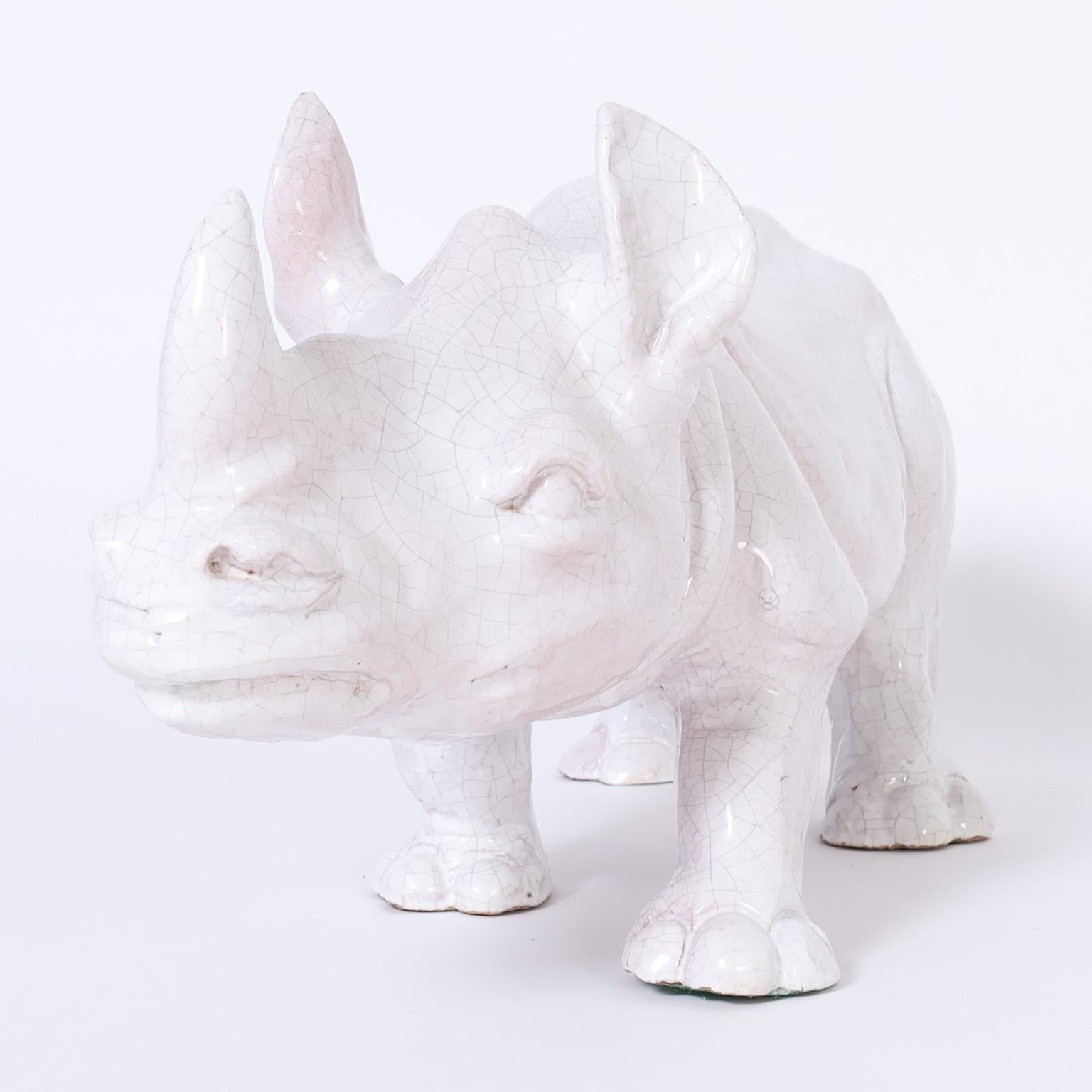 Mid century rhinoceros sculpture crafted in terra cotta with a white crackle glaze.