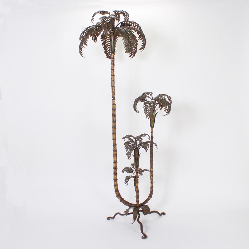 Tole palm tree sculpture with four separate palm trees at assorted stages of development. Original paint now muted and oxidized. All mounted on a handwrought organic shaped base.
