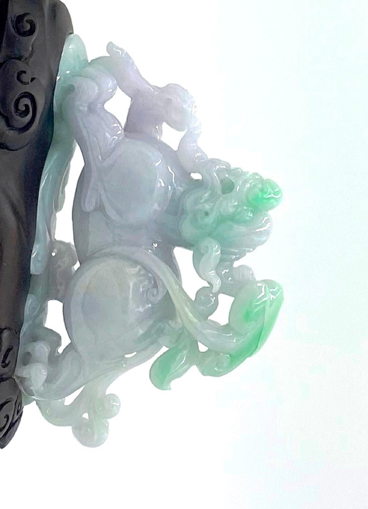 JD1317 
An exceptional Jadeite Jade carving with natural colors of Lavander, Light green and white Buddha statue, guarded by a Chinese Lion, decorated front and back on a custom made wood stand.  A passionate piece of traditional Buddhist Chinese