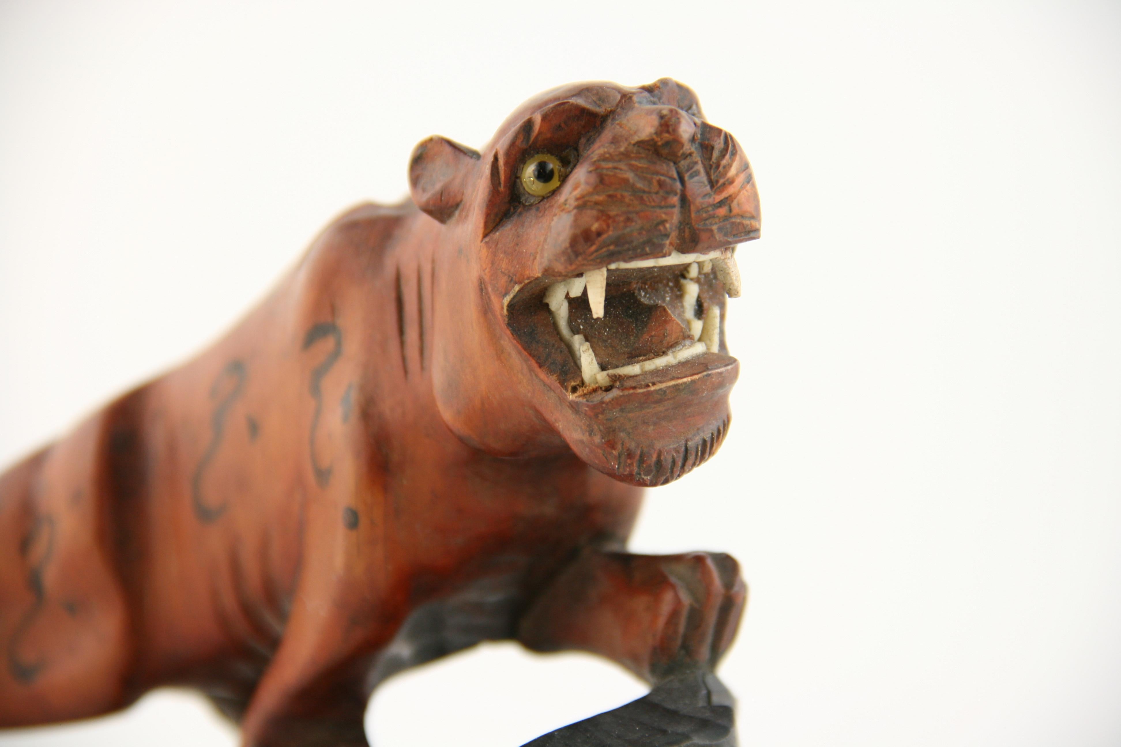 8-241 Japanese carved boxwood tiger with glass eyes and fanged tooth  in an art deco style circa 1920