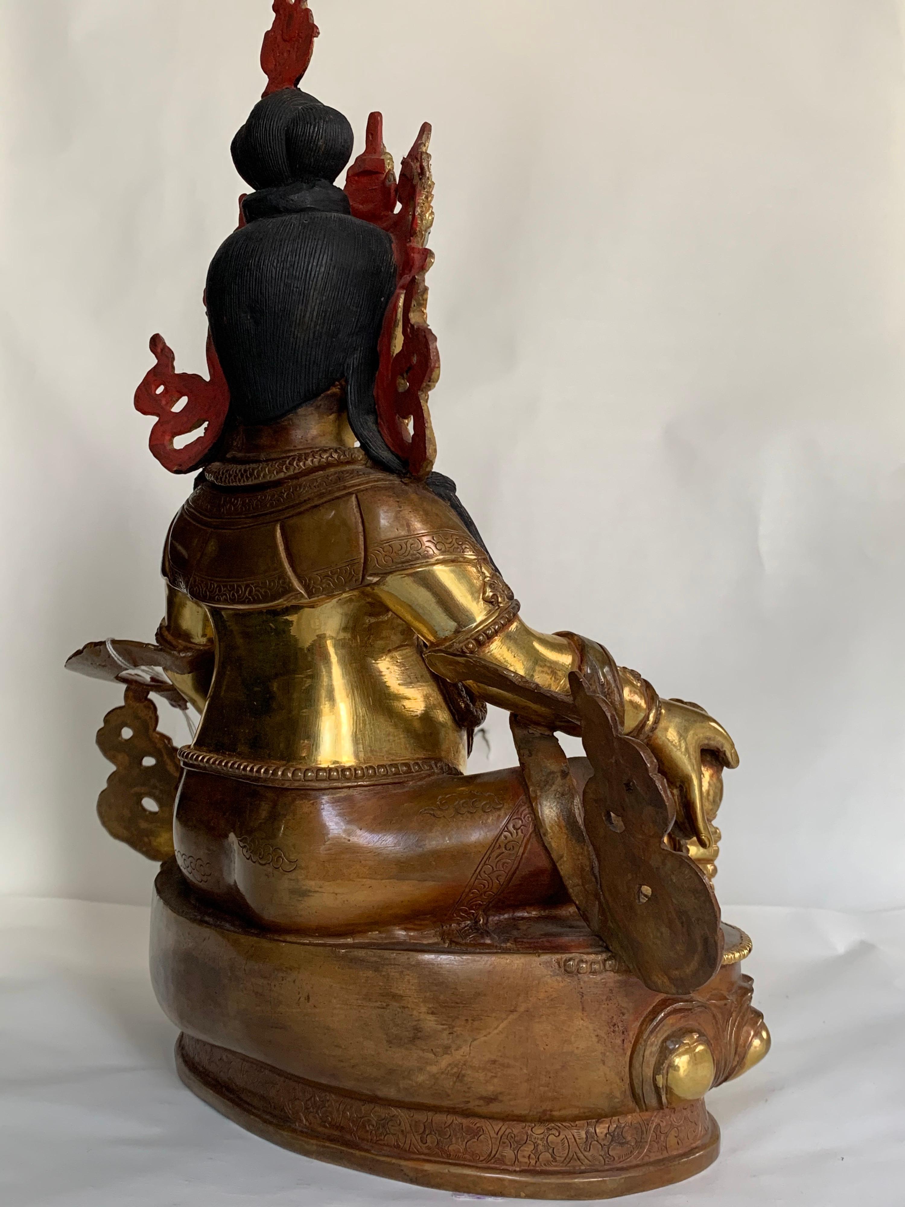 This statue is handcrafted by lost wax process which is one of the ancient process of metal craft. Kubera is seated in easy pose with one hand holding a jewel and another a mongoose. Kubera is also known as Vaishravana, the deity of wealth. He has a