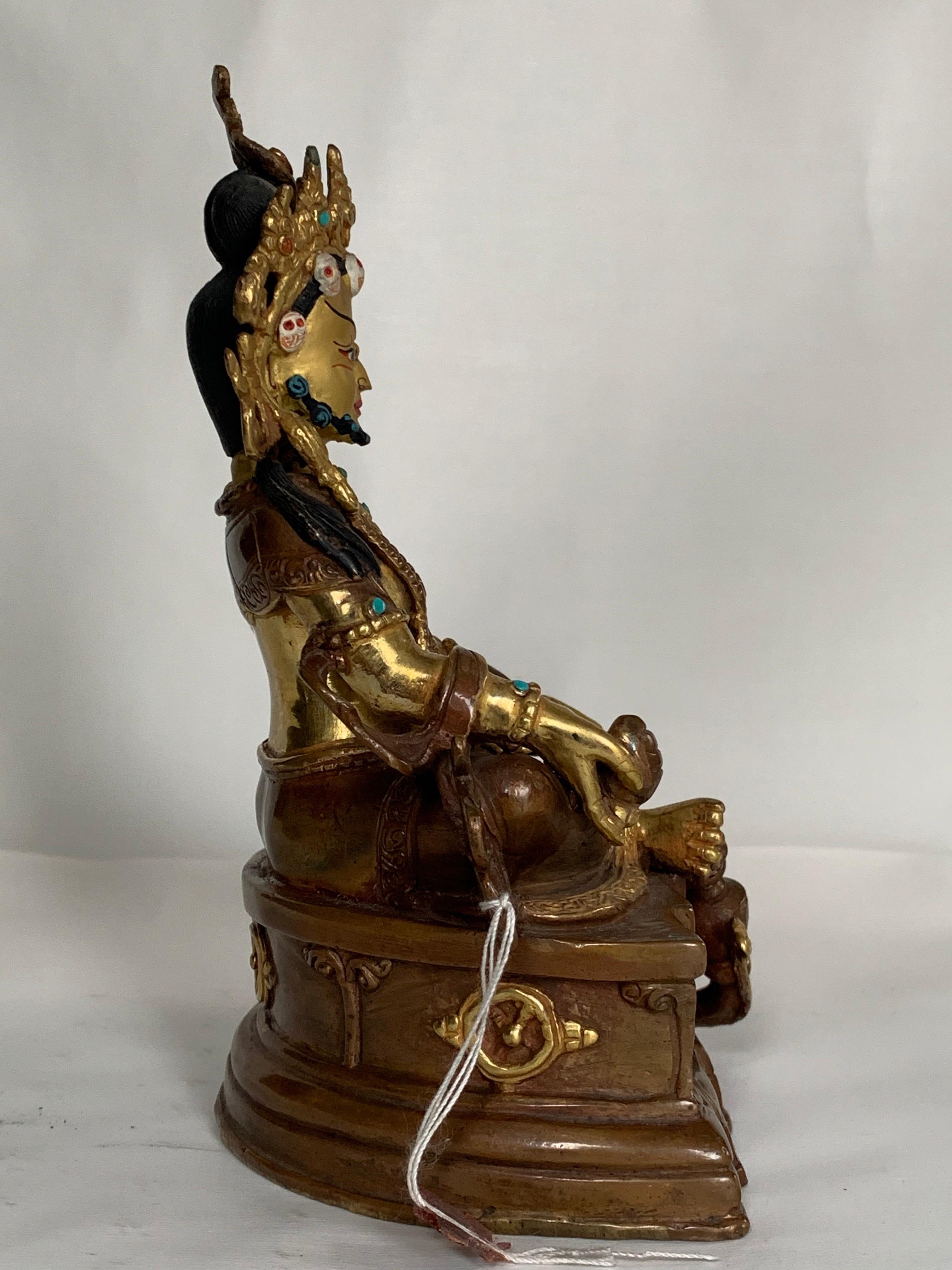 This statue is handcrafted by lost wax process which is one of the ancient process of metal craft. Kubera is seated in easy pose with one hand holding a jewel and another a mongoose. Kubera is also known as Jambala or Vaishravana, the deity of