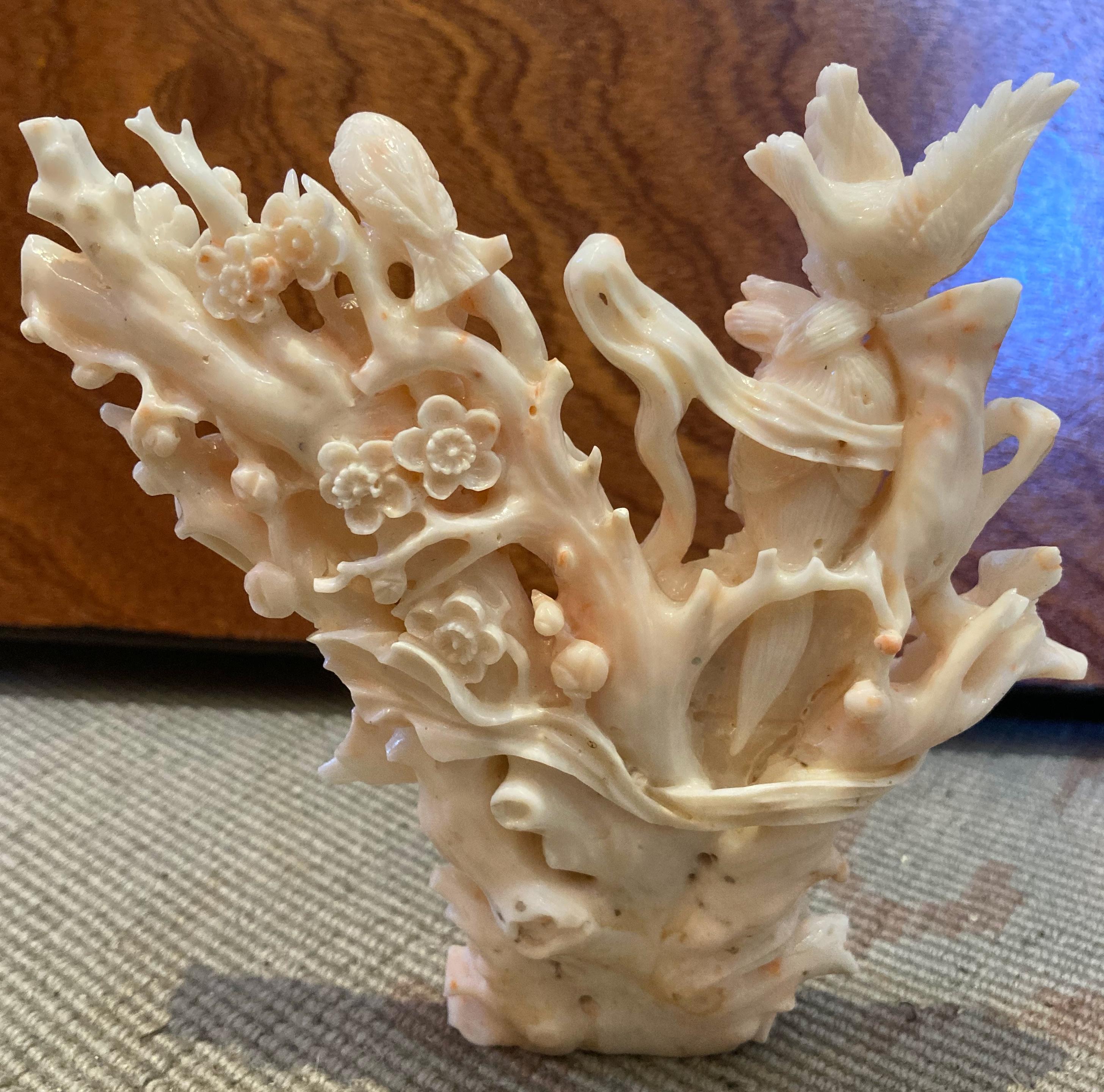 A fine carving of Kwan Yin (Guanyin) from a single branch of exceedingly rare angel skin coral. Kwan Yin is a Chinese Boddhisatva associated with compassion. From Wikipedia: 