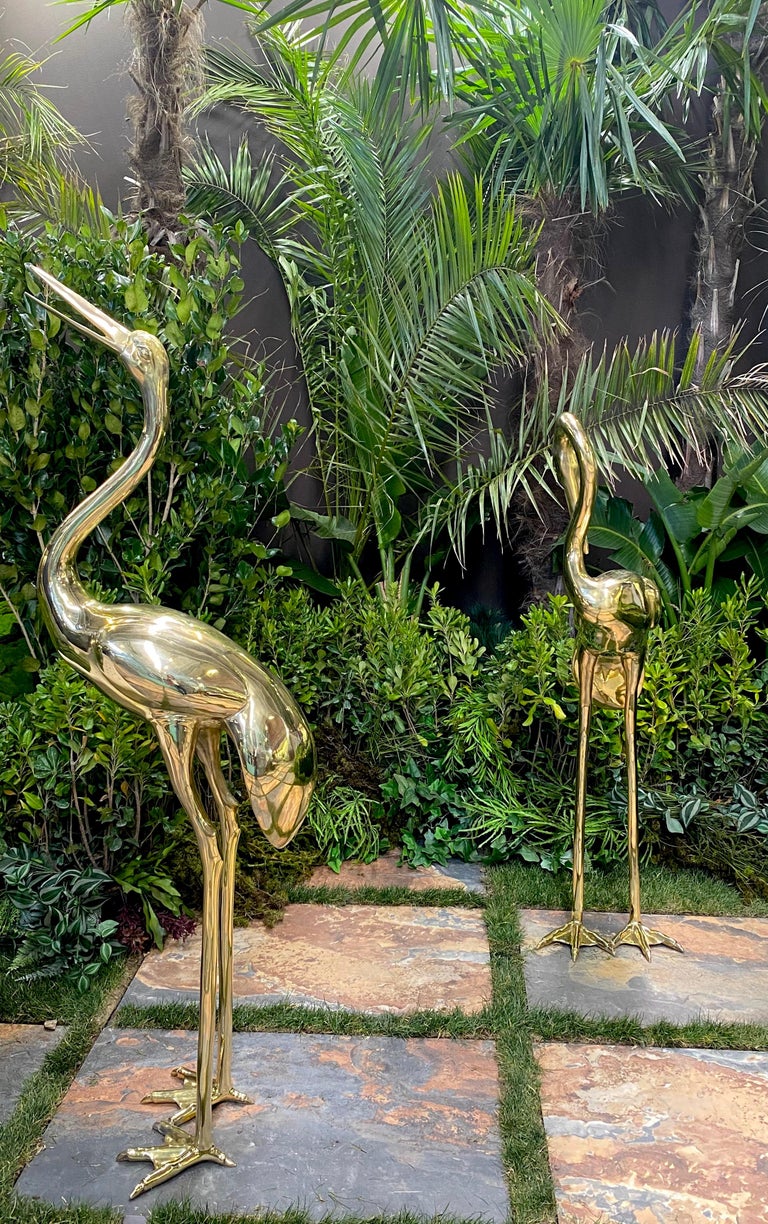Elegant pair of brass  heron sculptures . The item will be well-suited to either an indoor or outdoor setting.