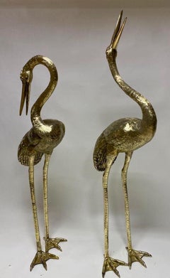 Grandes esculturas de bronce dorado de Garzas