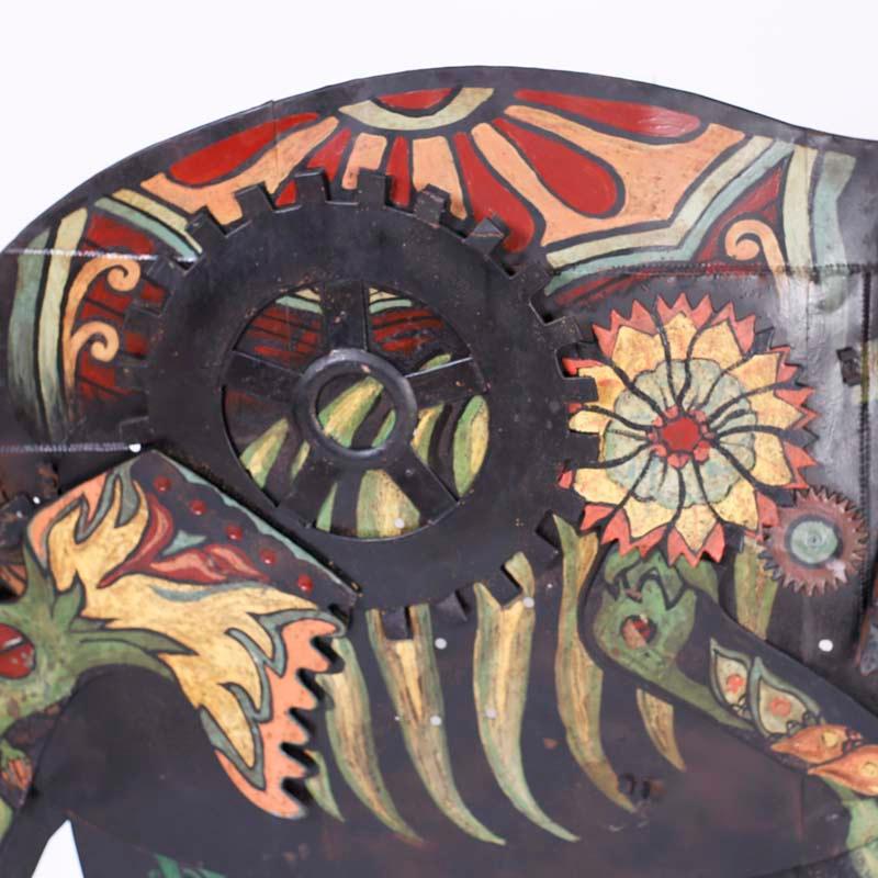 Bold one of a kind elephant wall sculpture hand crafted in metals with a stylized assemblage form decorated with paint in eccentric colorful floral designs.