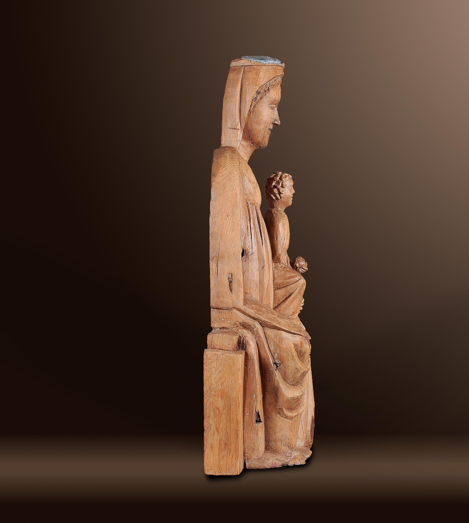 LATE ROMANESQUE MADONNA 
“Sedes Sapientiae”
Switzerland/Wahliss 
Around 1250 
Pine wood/Zirbe? 
Height 65.5 cm 

Provenance: 
Tyrolean private collection 

This seated Madonna of the Sedes Sapientiae (“Seat of Wisdom”) type was carved from pine wood