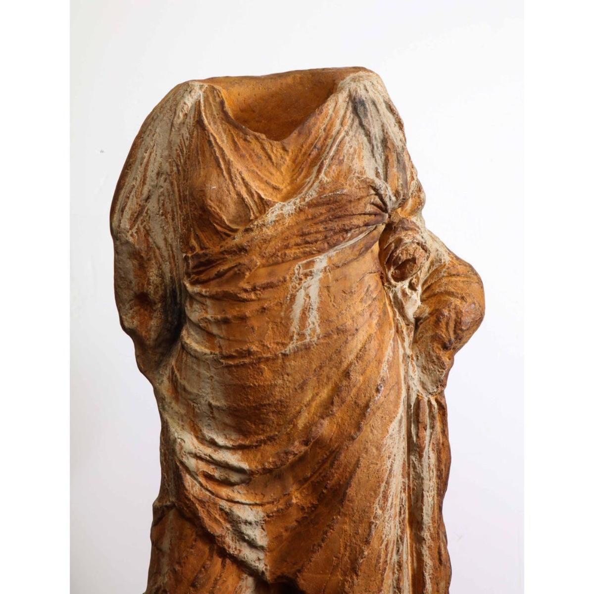 A modern life-size Roman style fiberglass torso, after the antique, mounted on a metal post and stand,  circa 1960.  

Made of rusted-color patinated fiberglass. 

Extremely decorative life-size sculpture that would look amazing in any room. 