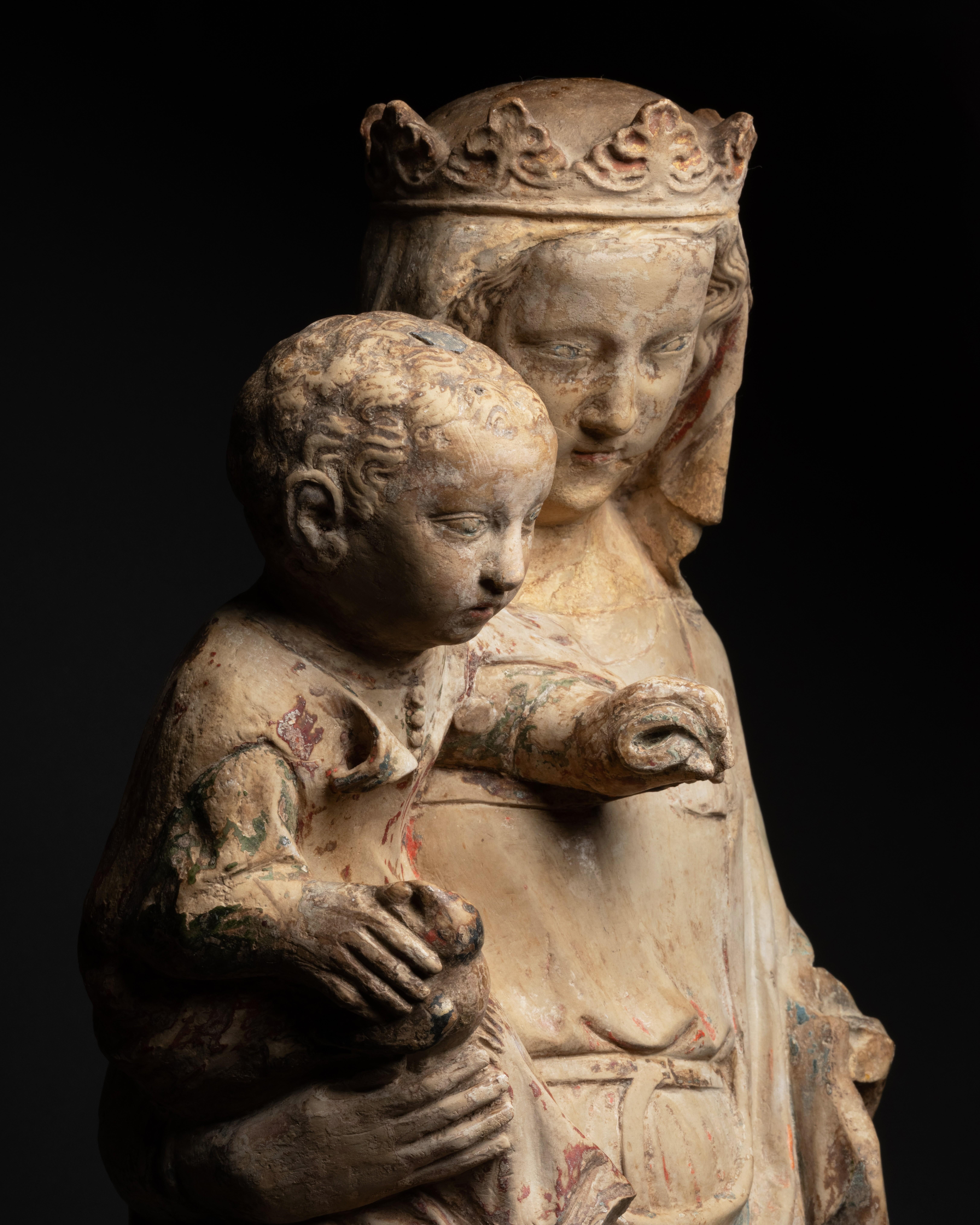 Virgin and Child with Goldfinch
Workshops of Metz, Lorraine, circa 1330
Limestone carved in the round with remains of polychromy
Height: 61 cm

The sculpture of the Virgin and Child that we present belongs, by its stylistic characteristics, to the