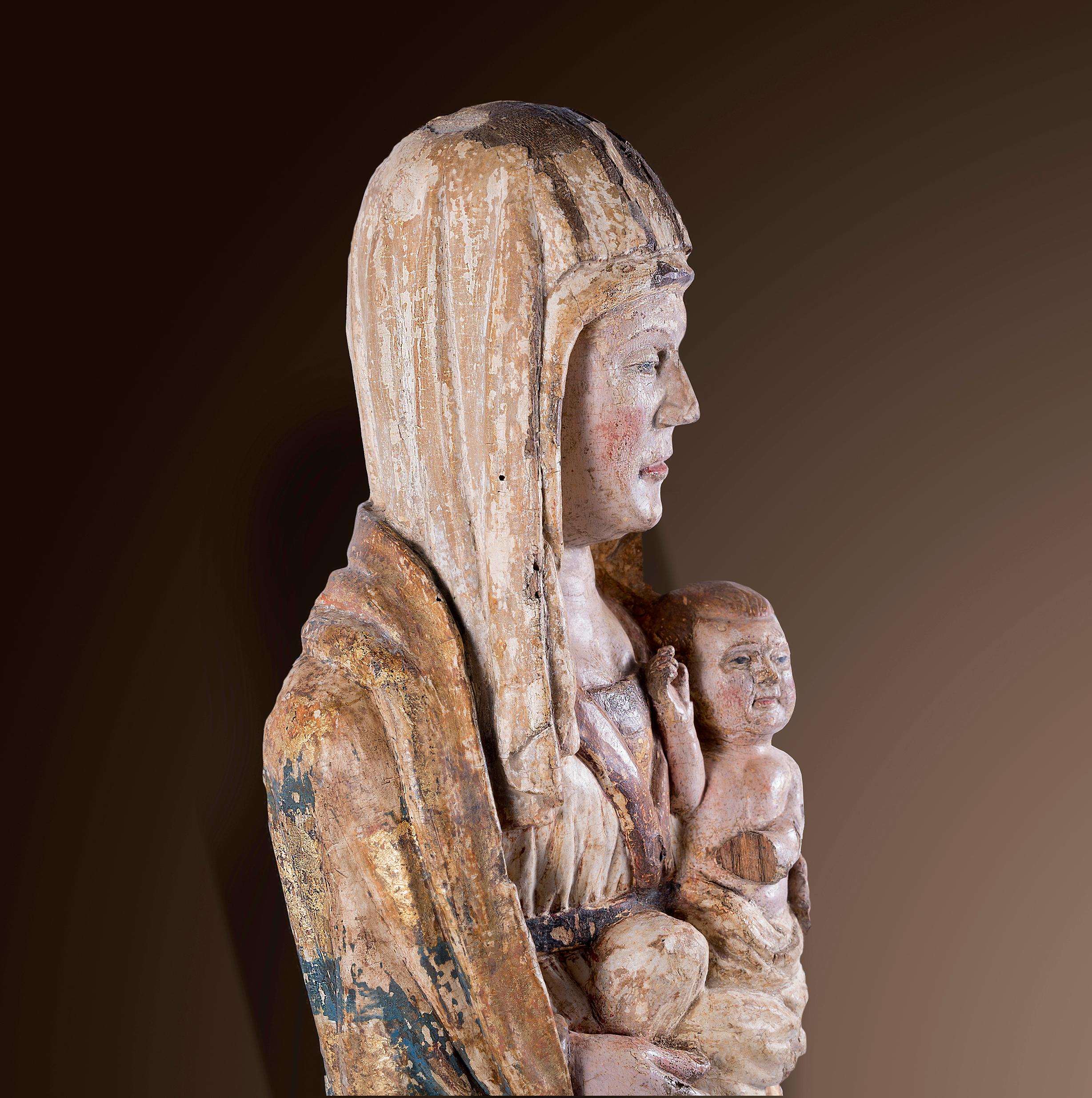 EXTREMELY RARE MADONNA
Lake Constance area 
Around 1300 
Carved votive wood 
Original, polychrome version 
Height 59 cm 

Provenance: 
Swiss private collection 

This Madonna figure was created around 1300 in the Lake Constance region. It is carved