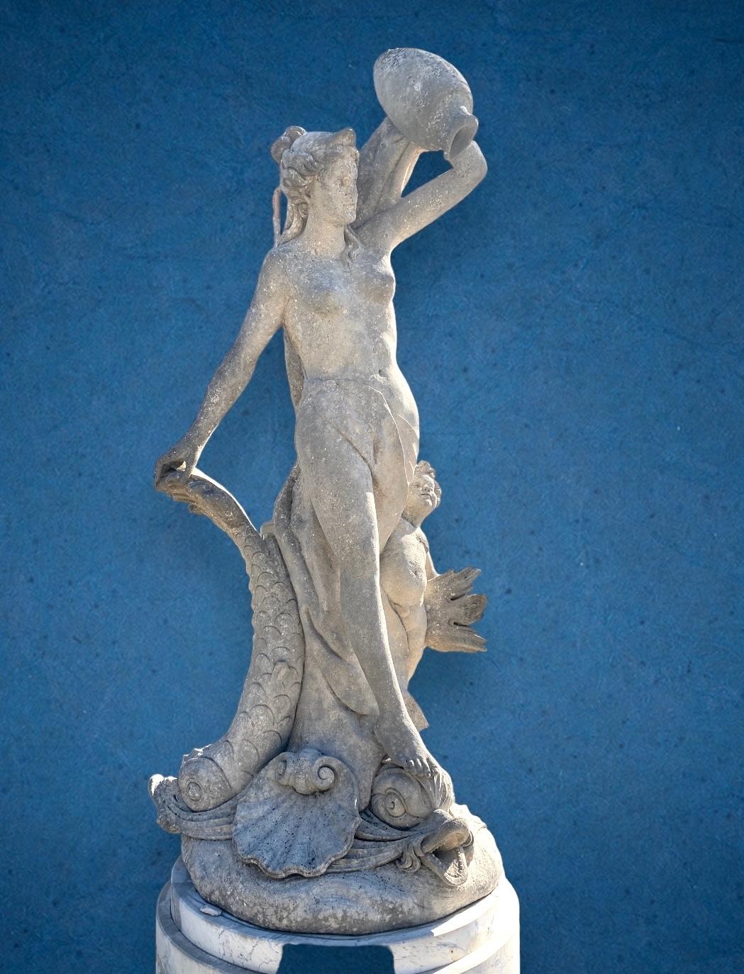 Monumental finely carved limestone fountain sculpture of Goddess with a putto figure and  three magnificent dolphins . 
Proveniente from an important Villa Veneta.
Including a round shape marble base. 
 The sculpture is in a very good condition with