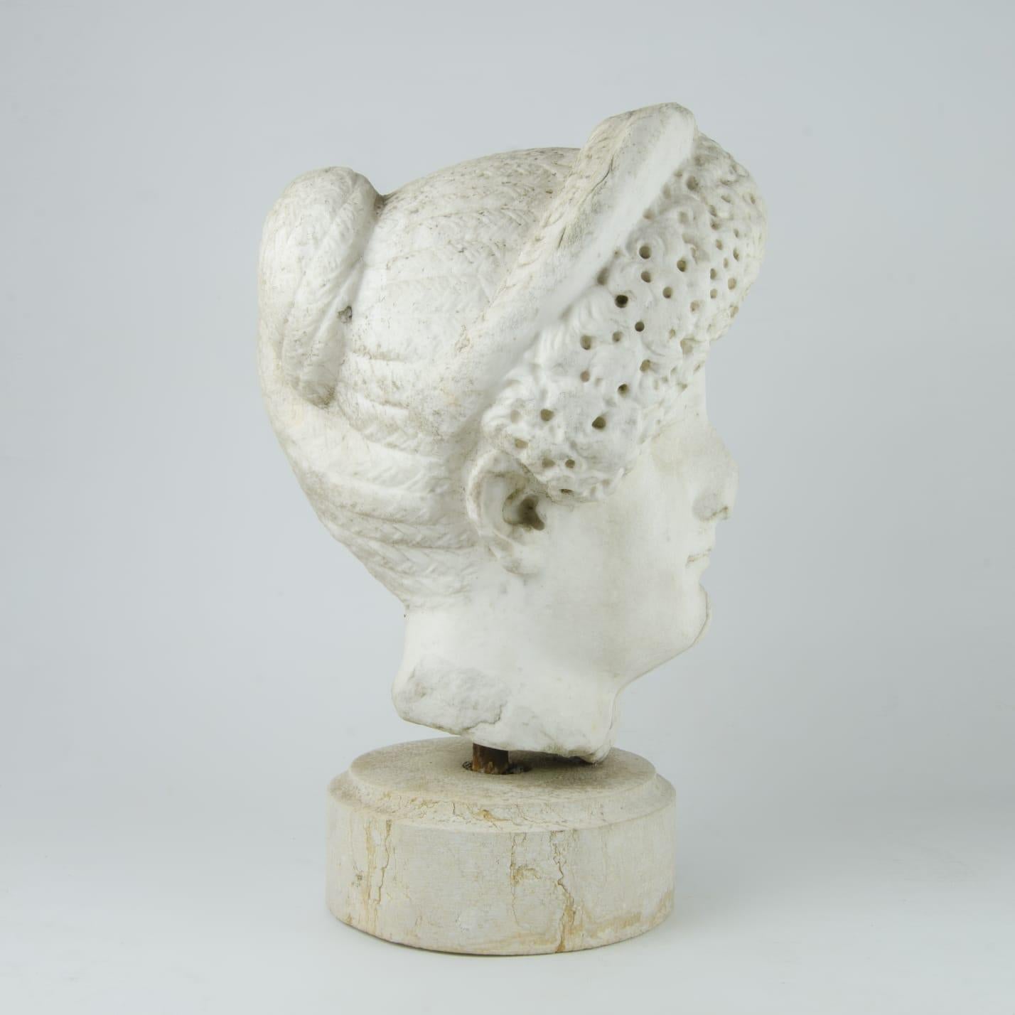 Marble head of Roman empress Domitia Longina, wife of emperor Domitian. The elaborate hairstyle, a distinctive feature of Domitia's depictions, is worked in great detail, and the serenity of her facial features reflects the idealisation of the