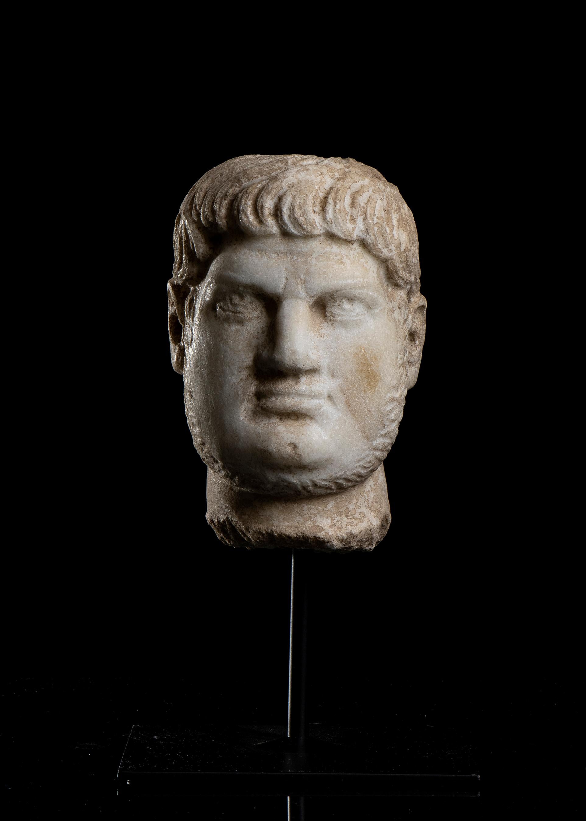 An Italian marble sculpture head, carved in white aged statuary marble probably in central Italy in the first half of the 20th Century, depicting the Roman Emperor Nero Claudius Caesar Augustus Germanicus universally know as Nero and of of the most