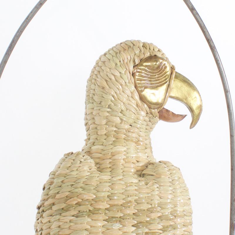 Amusing midcentury Mario Torres wicker parrot perched on a metal swing. Having a brass face and beak he appears to be saying Polly wants a cracker.
