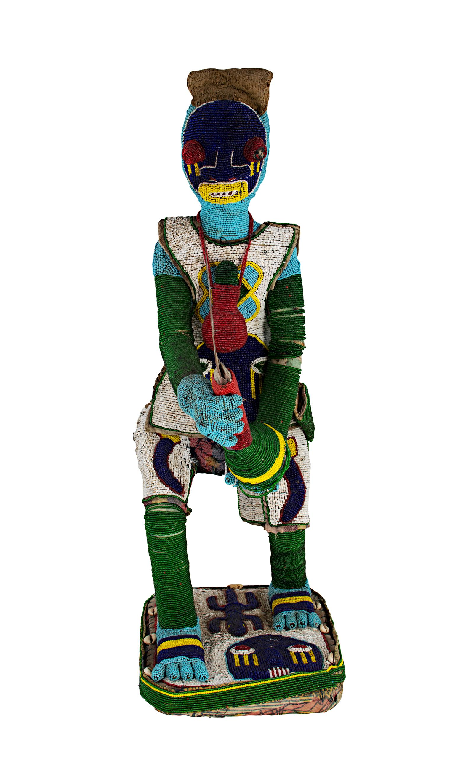 Unknown Figurative Sculpture - "Medicine Man"--African Wooden Sculpture with Glass Beads, Cloth, Bell, & Shells