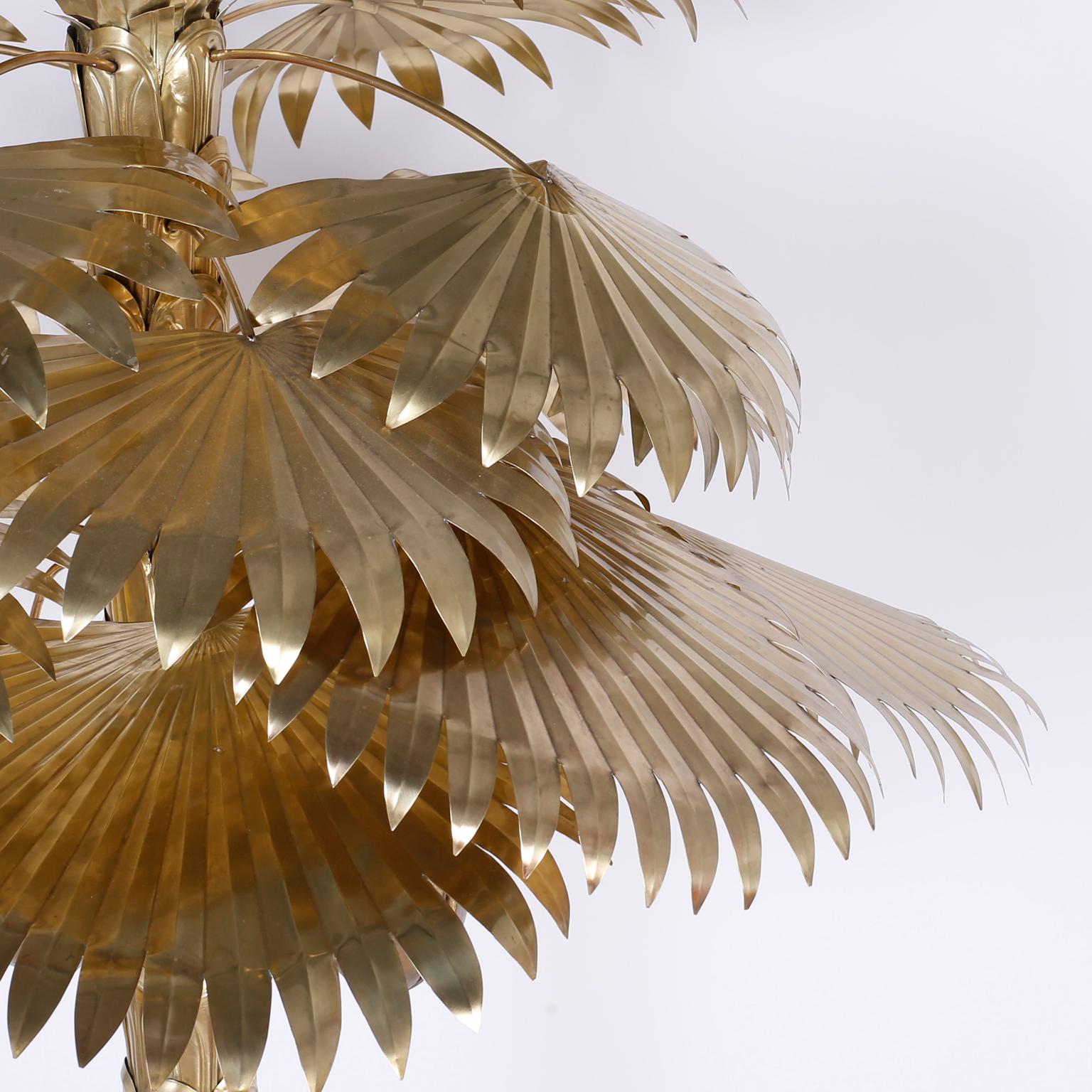 Mid century brass palm tree, in the Maison Jansen manner with a refined presence and dynamic appeal. Having removable fronds and coconuts, all hand polished and lacquered for easy care. The zinc or lead base is cement filled for balance.