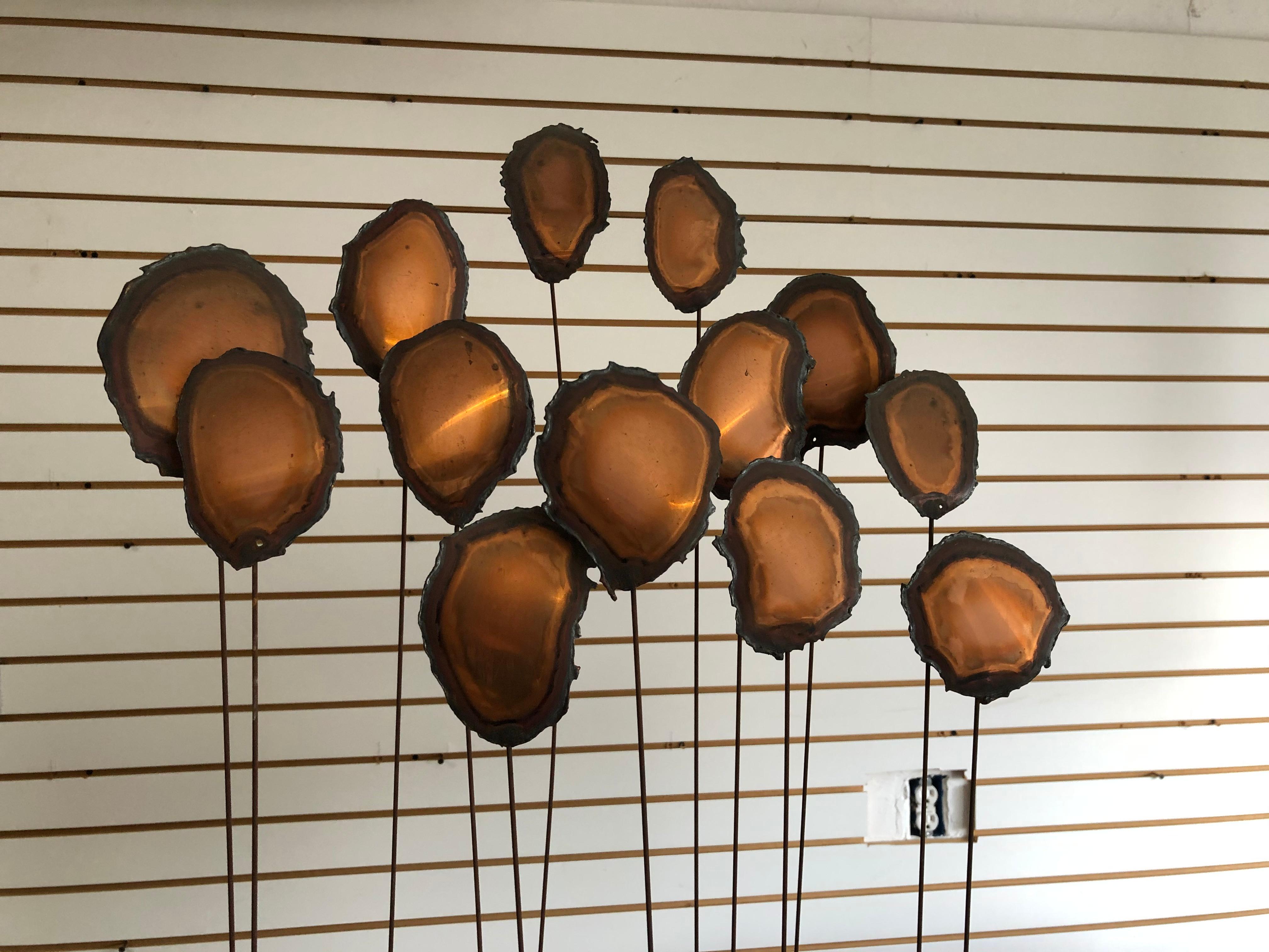 Fantastic intricate brutalist metal sculpture. Most likely from mid 20th century. I feel they could represent flowers while my kids think they are balloons. Looks to be copper and metal measuring approximately 31 inches high by 16 wide. The base is