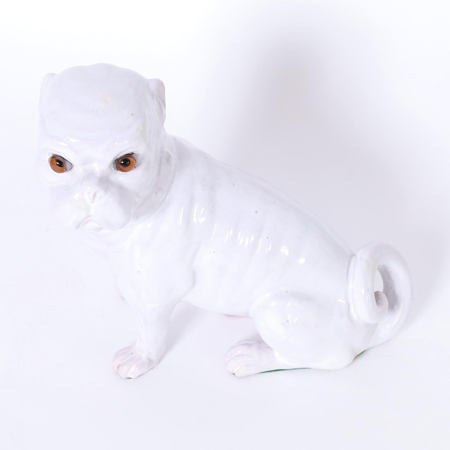 Vintage Italian French bulldog statue or sculpture crafted in terra cotta with a white glaze and glass eyes.