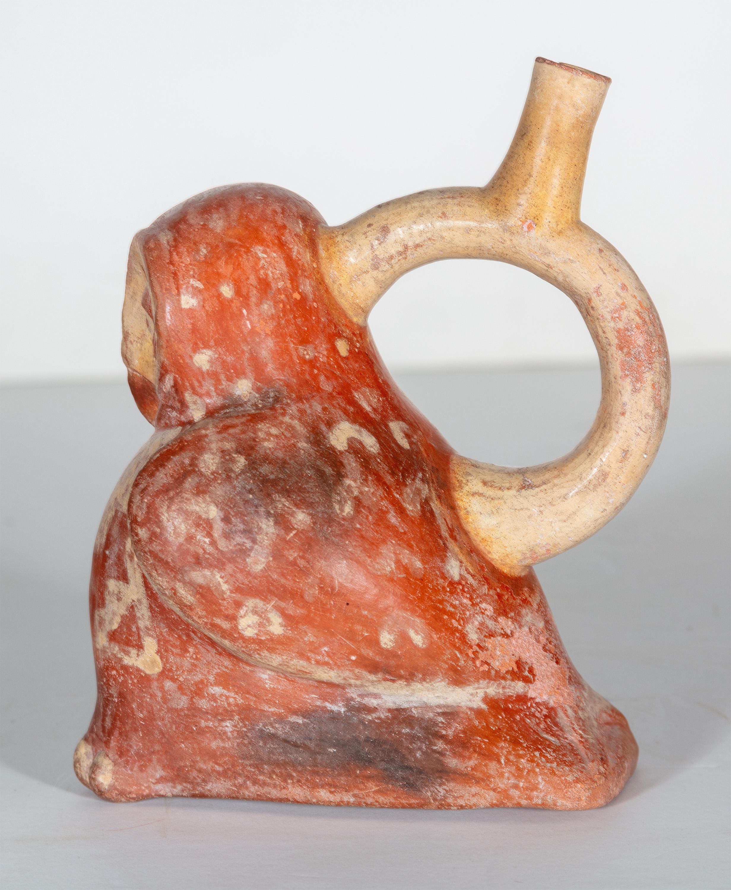 This piece is a pot made by an unknown artist in Pre-Columbian Peru. It takes the shape of an owl and has a circular handle with the opening on its back. This pot is a light beige and red ocher color. 

8