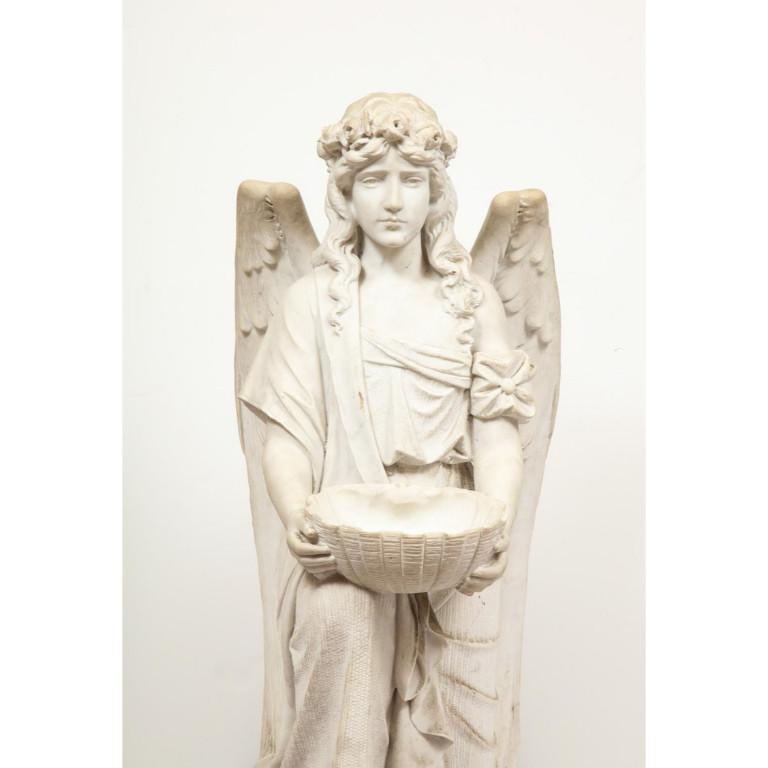 Monumental Italian white marble figure sculpture of a seated winged woman, Rome, 1870.  Depicting a seated female winged woman, holding a basket bowl on base.  Extremely finely carved by a master Italian sculptor.  Measures: 45