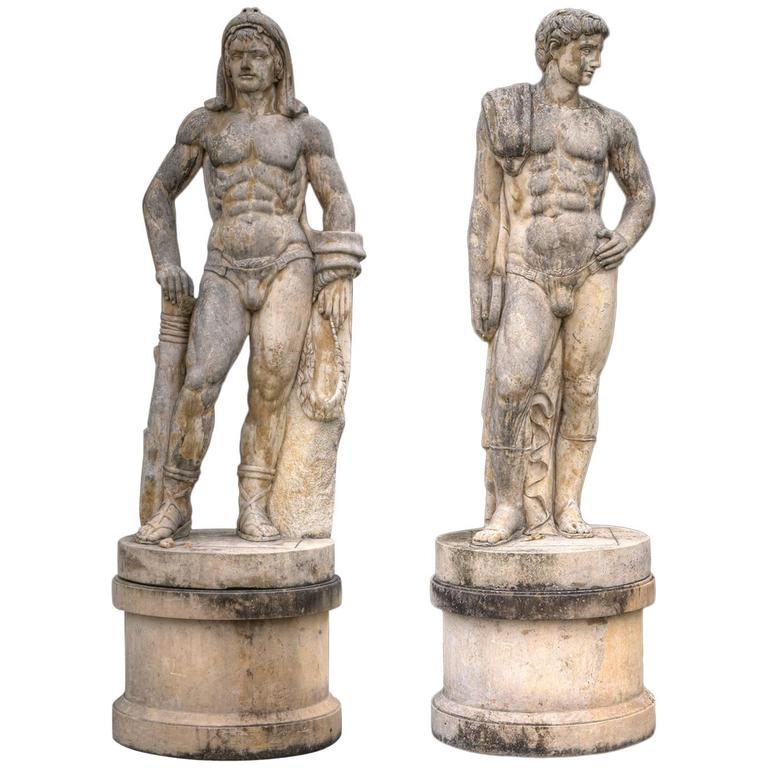 This monumental pair of sculptures in "Bardiglio" marble represent Greek Athlete of Discobolo and the Hercules figure with a lion pelt, on a cylindrical base . Exaltation of the male strength and beauty, inspired by the trend in Italian sculpture in