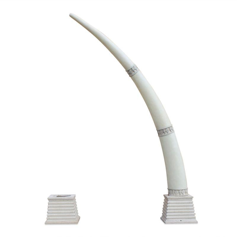 Seriously monumental, custom midcentury pair of fabricated composition faux elephant tusks decorated with Egyptian style rings in faux stone. Set in heavy cast stepped bases anchoring cantilevered weight. Sophisticated fantasy for a dramatic