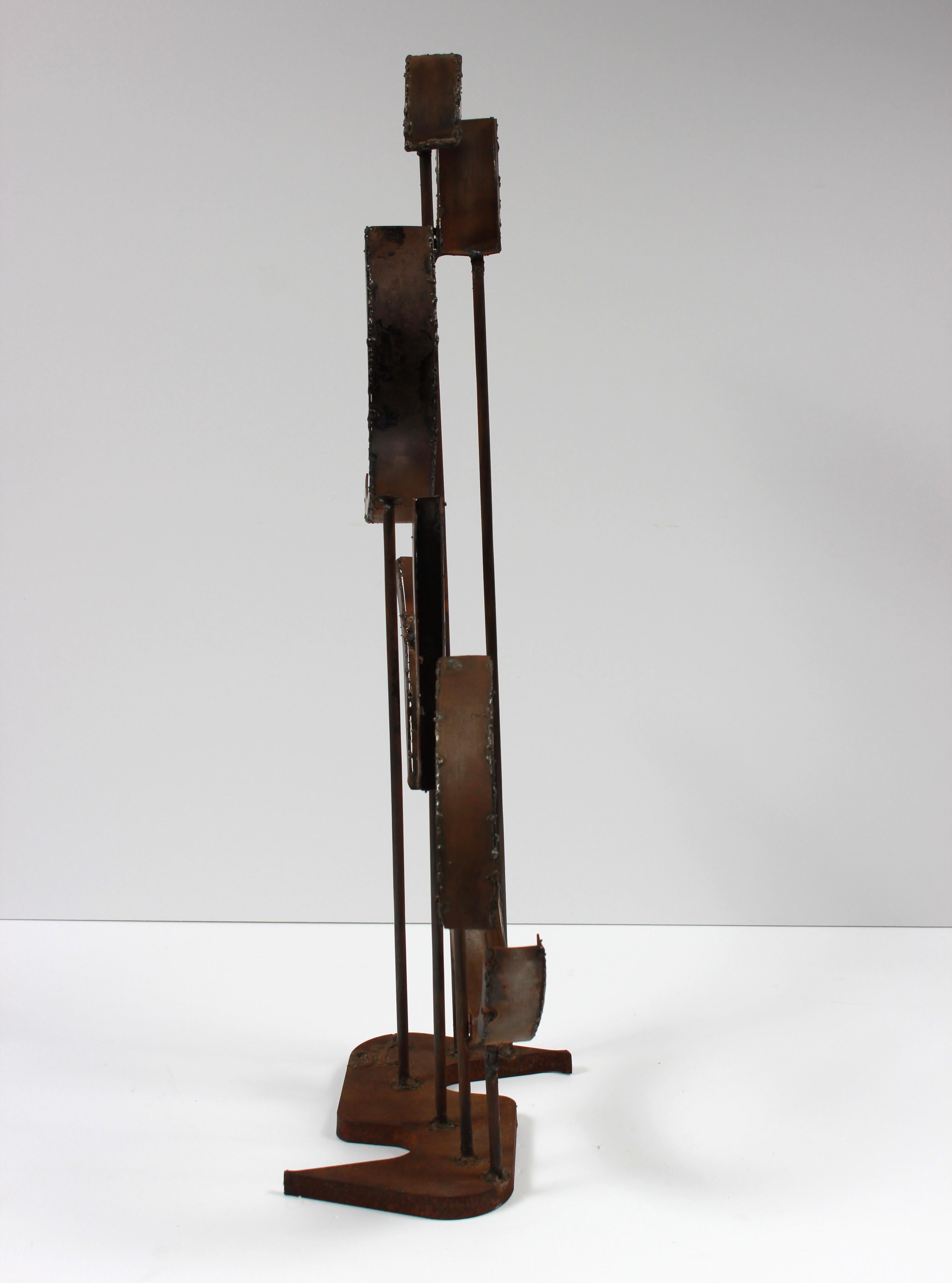 This late 20th century geometric multimedia welded metal sculpture stands on its own and is signed by the artist at the bottom.  Purchased from a collector and part of a larger body of sculptural work.