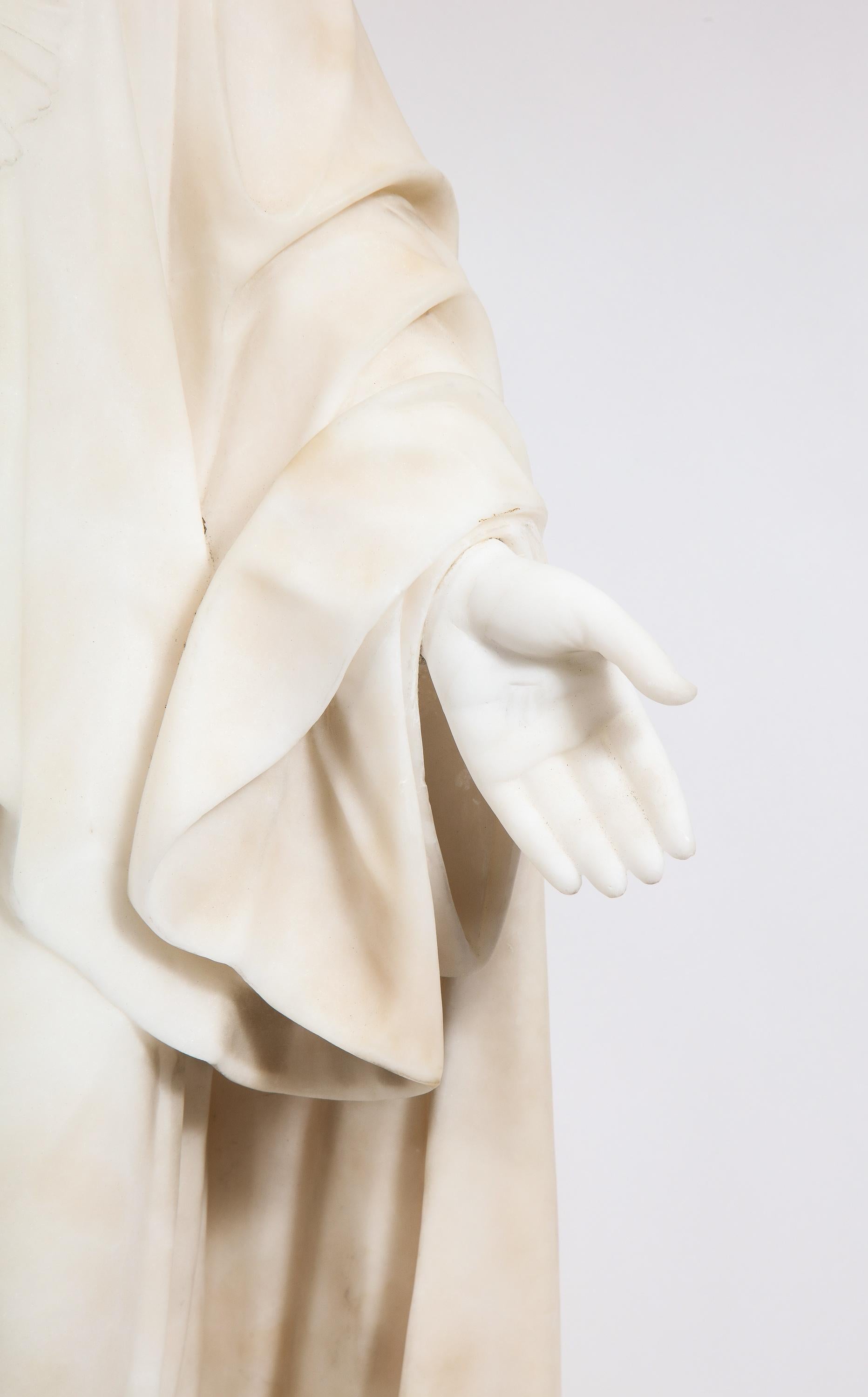 Italian Marble Sculpture Statue of Holy Jesus Christ, 19th Century. 

Exceptionally carved white-carrara marble sculpture depicting Jesus Christ standing with his palms open wearing his sacred heart. Marble from the 19th century, carved in Italy by