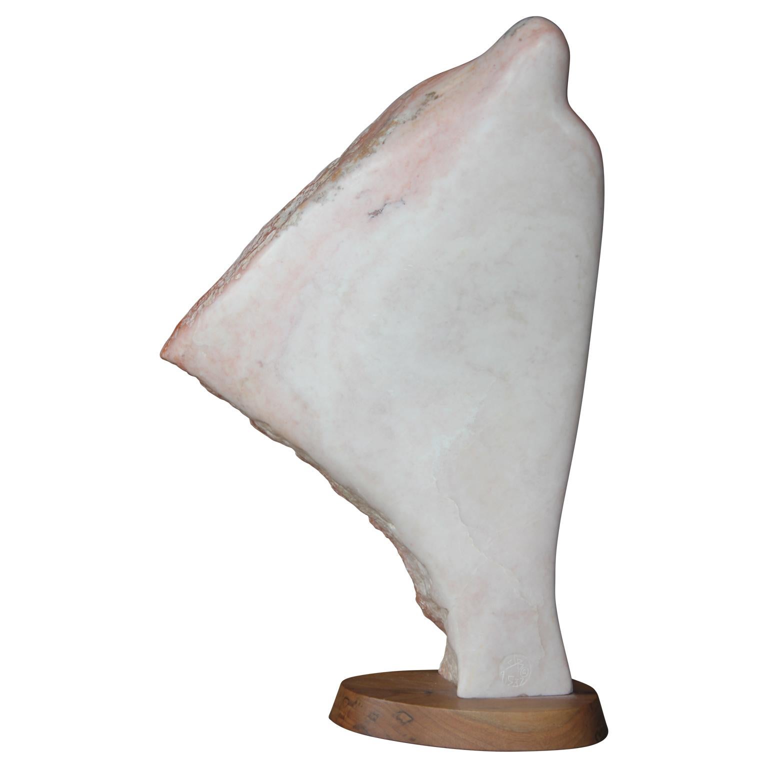 A delicately sculpted native New Mexico pink marble sculpture of a hooded figure draped in a cloak. Attached to a dark wooden base which compliments the beautiful pink tones of the sculpture.

