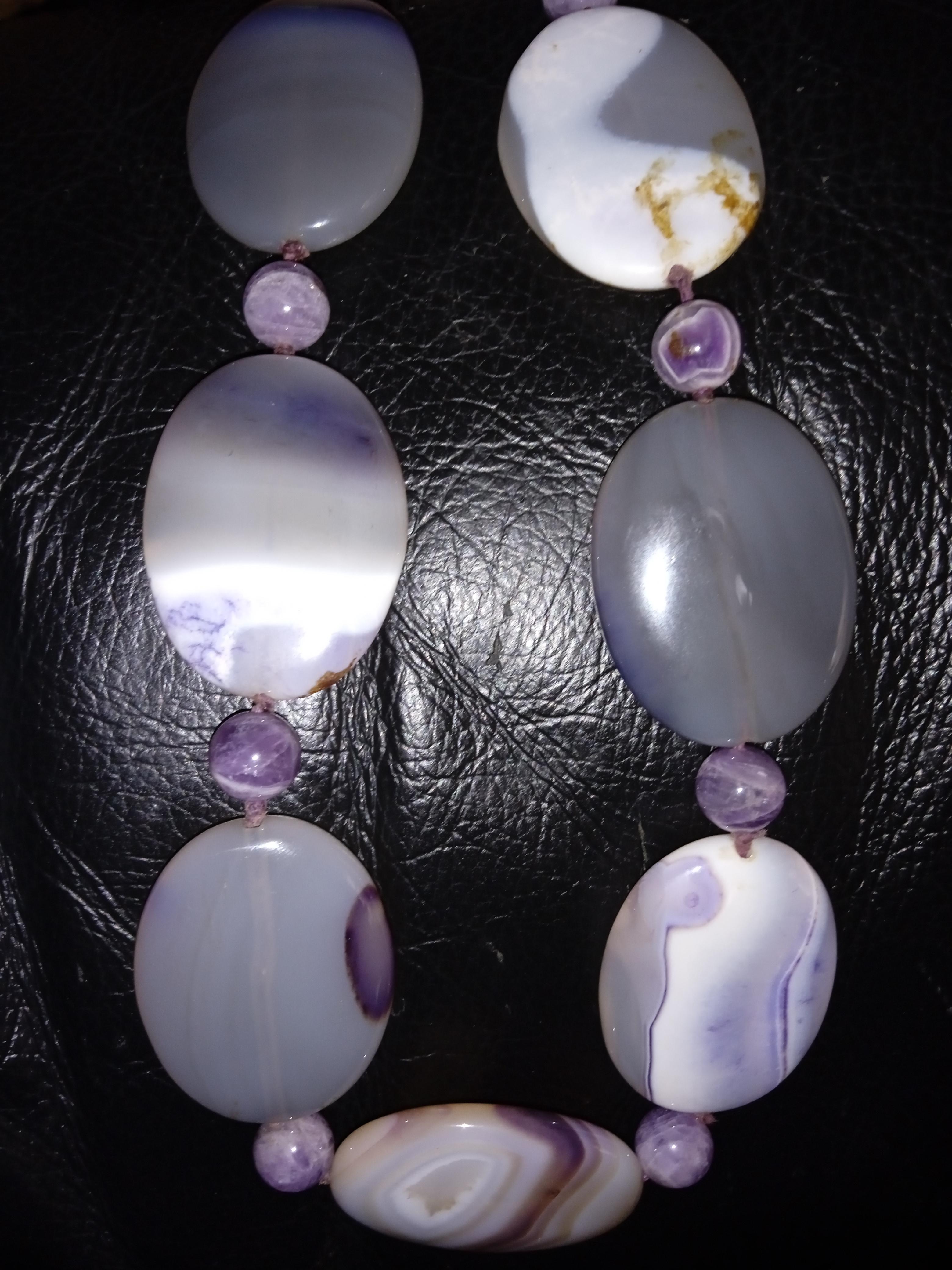 Add a touch of nature to your jewellery collection with this handmade Natural Purple Agate Necklace. The choker style necklace features a gorgeous multicoloured Agate stone as the main stone, and is adjustable to fit any neck size with a hook