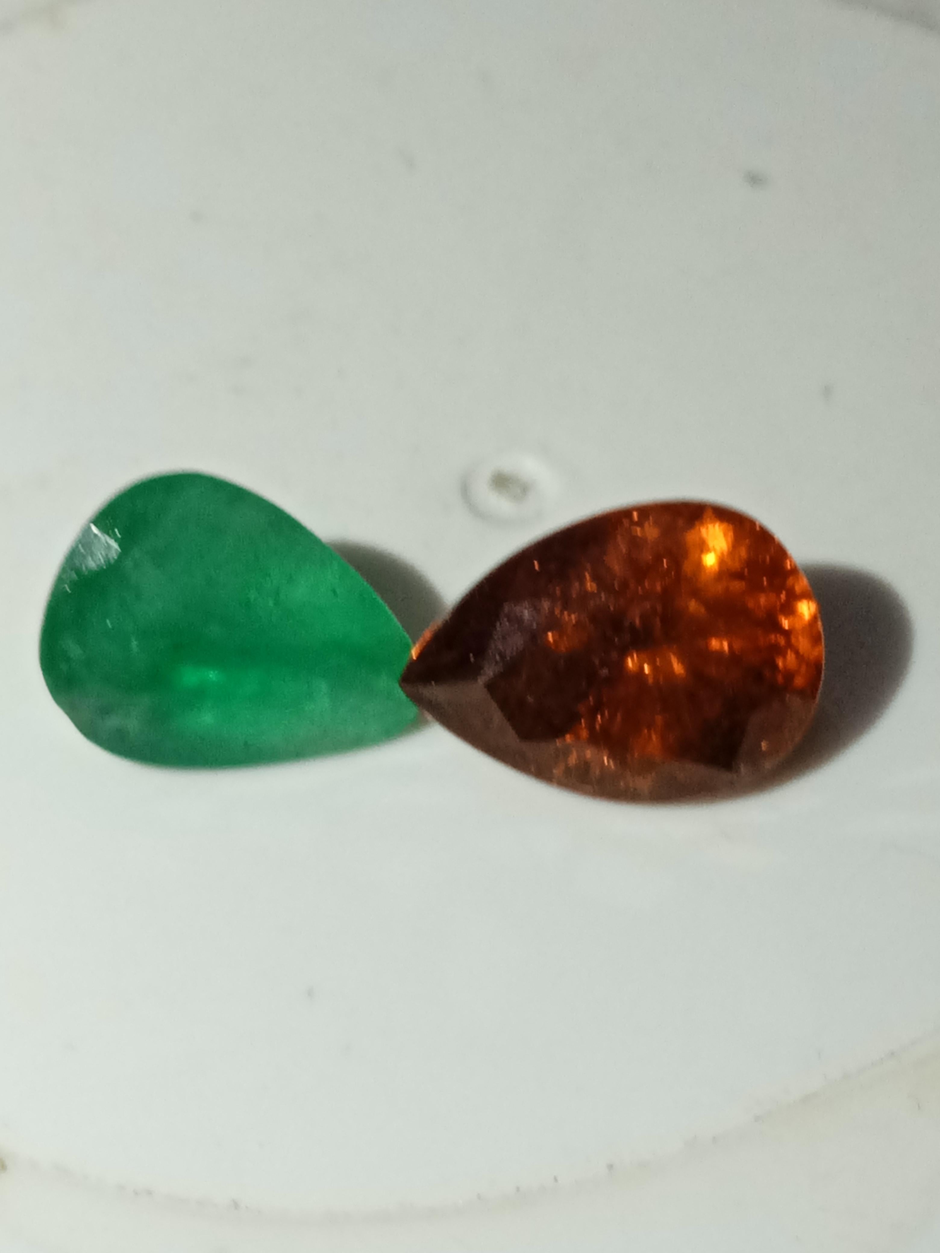 Natural Zambia emerald and spessitite garnet both weights 505 caratsAdd a touch of elegance and sophistication to your jewellery collection with this stunning pair of Natural Zambia Emerald & Spesitite Garnet. The pear-shaped gemstones boast a