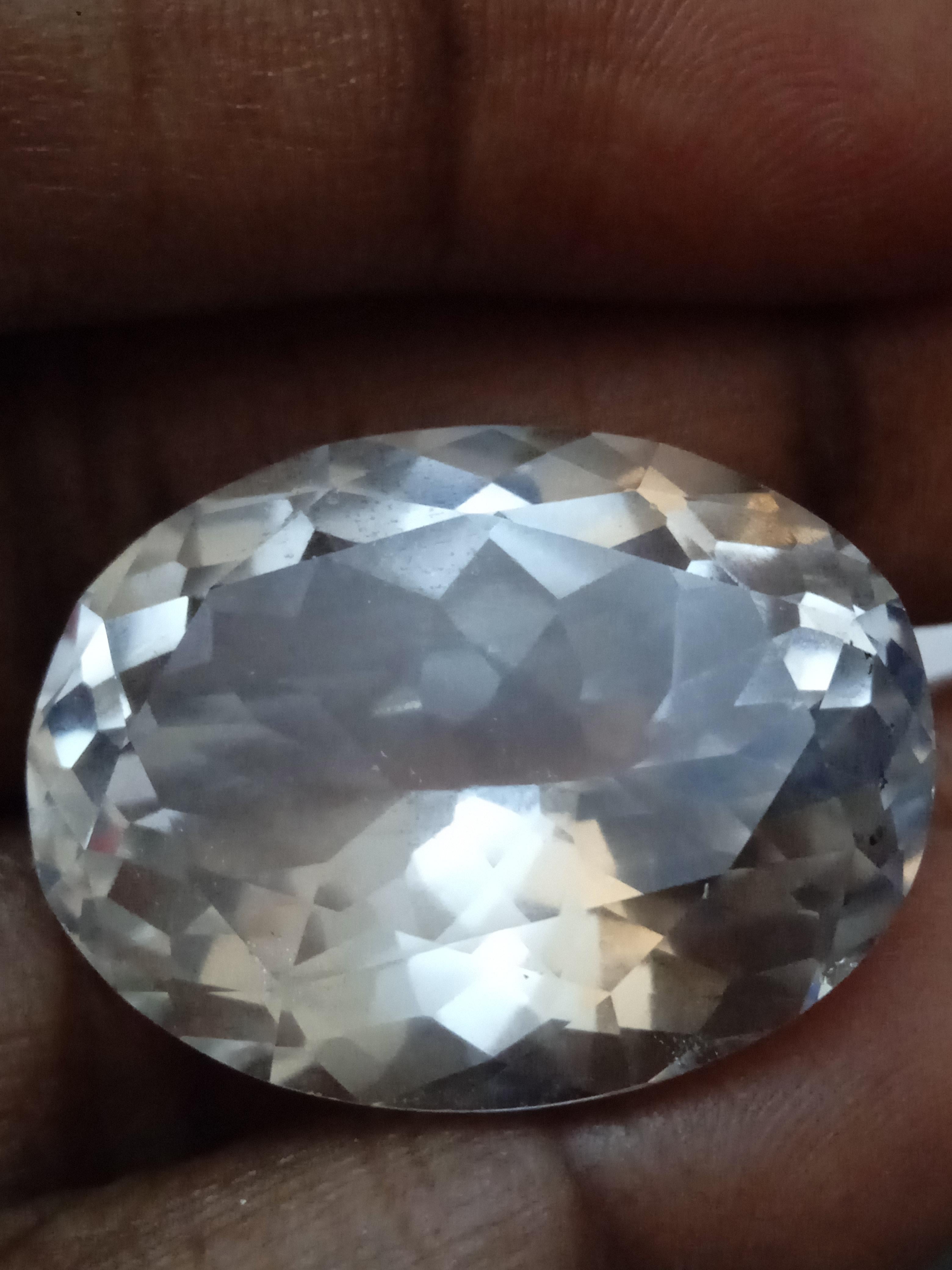 This exquisite White Beryl gemstone boasts excellent cut grade and loupe-clean clarity. Measuring at 10mm in length and 20mm in width, this oval-shaped gem was naturally created and has not been enhanced in any way. With a total weight of 49 carats,