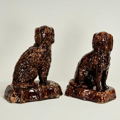 Near Pair of Antique Rockingham Pottery Dogs