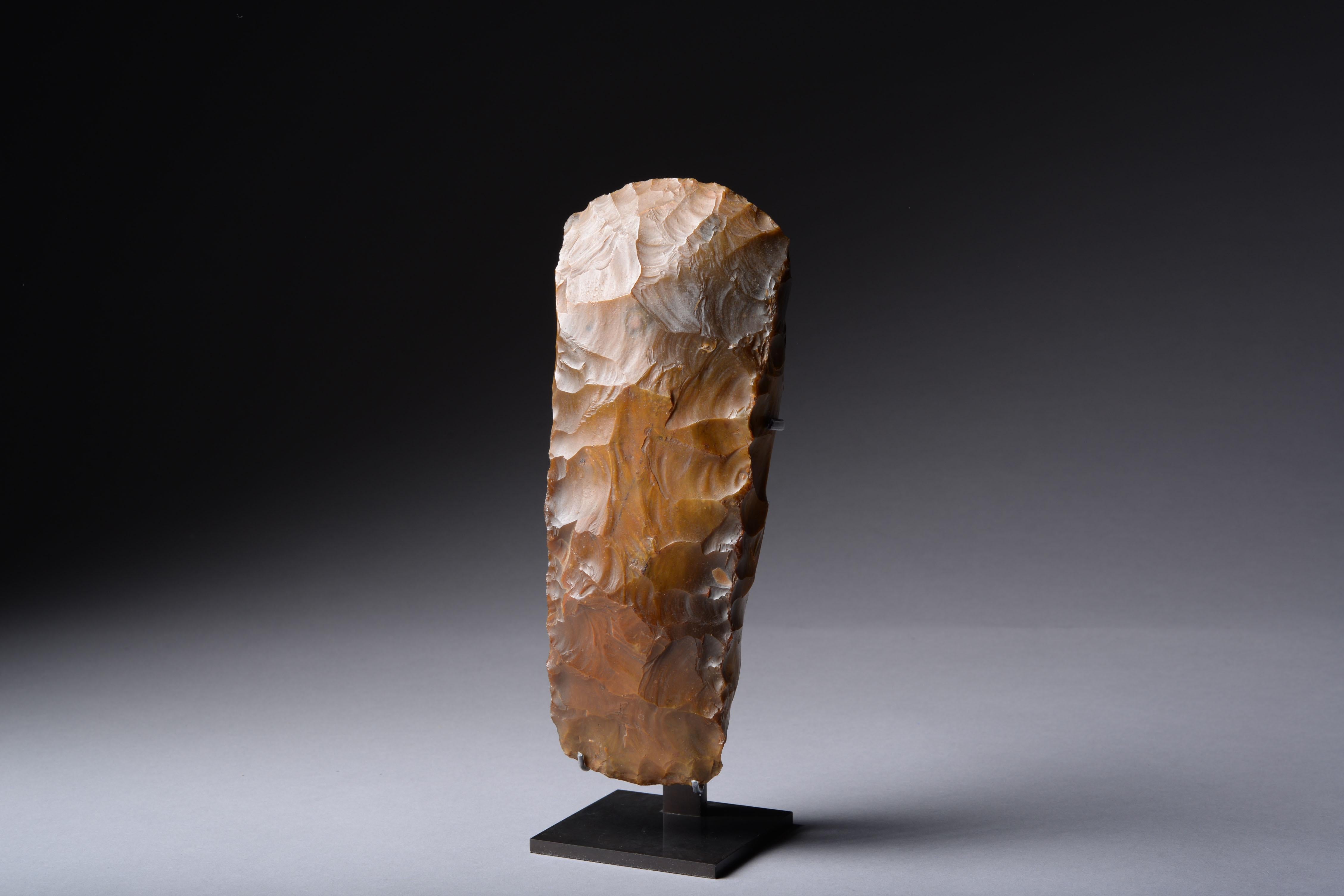 This tactile and beautifully patinated tool was finely knapped from a piece of mottled caramel-coloured flint.

It was crafted in Denmark during the Neolithic Revolution, a period which saw the transition from hunting and gathering to a more