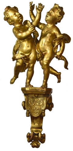 Pair of angels on a console, gilt wood, Regency era.