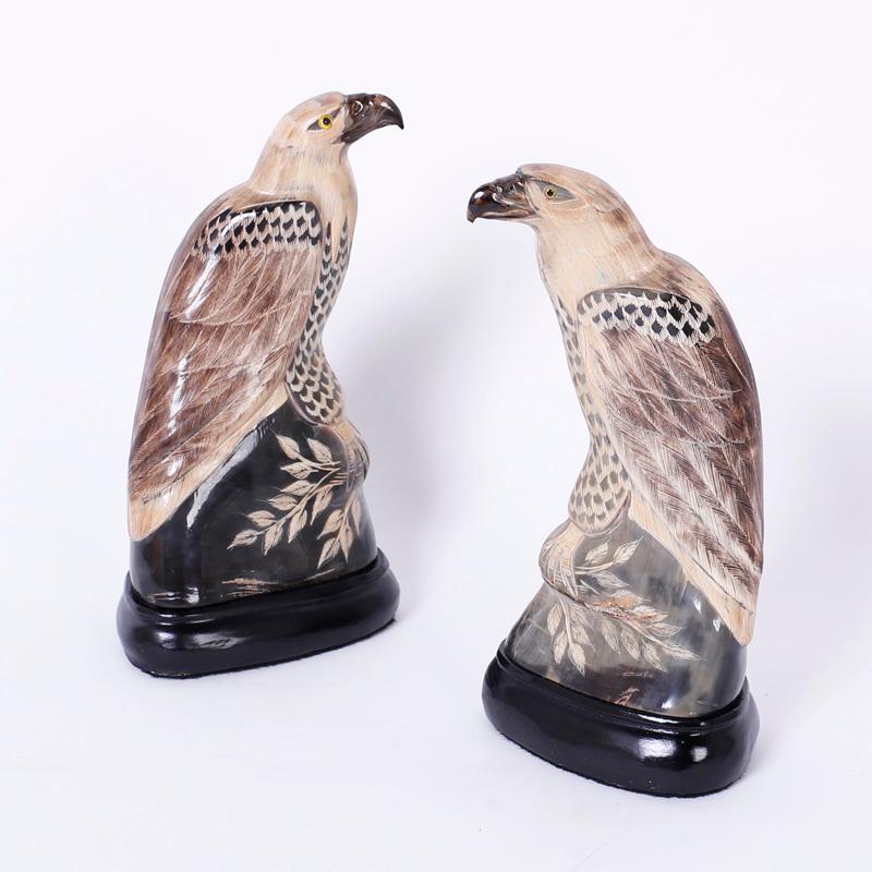 Pair of Chinese vintage carved and painted horn eagles or hawks with an alluring, stylized interpretation of these majestic birds of prey.