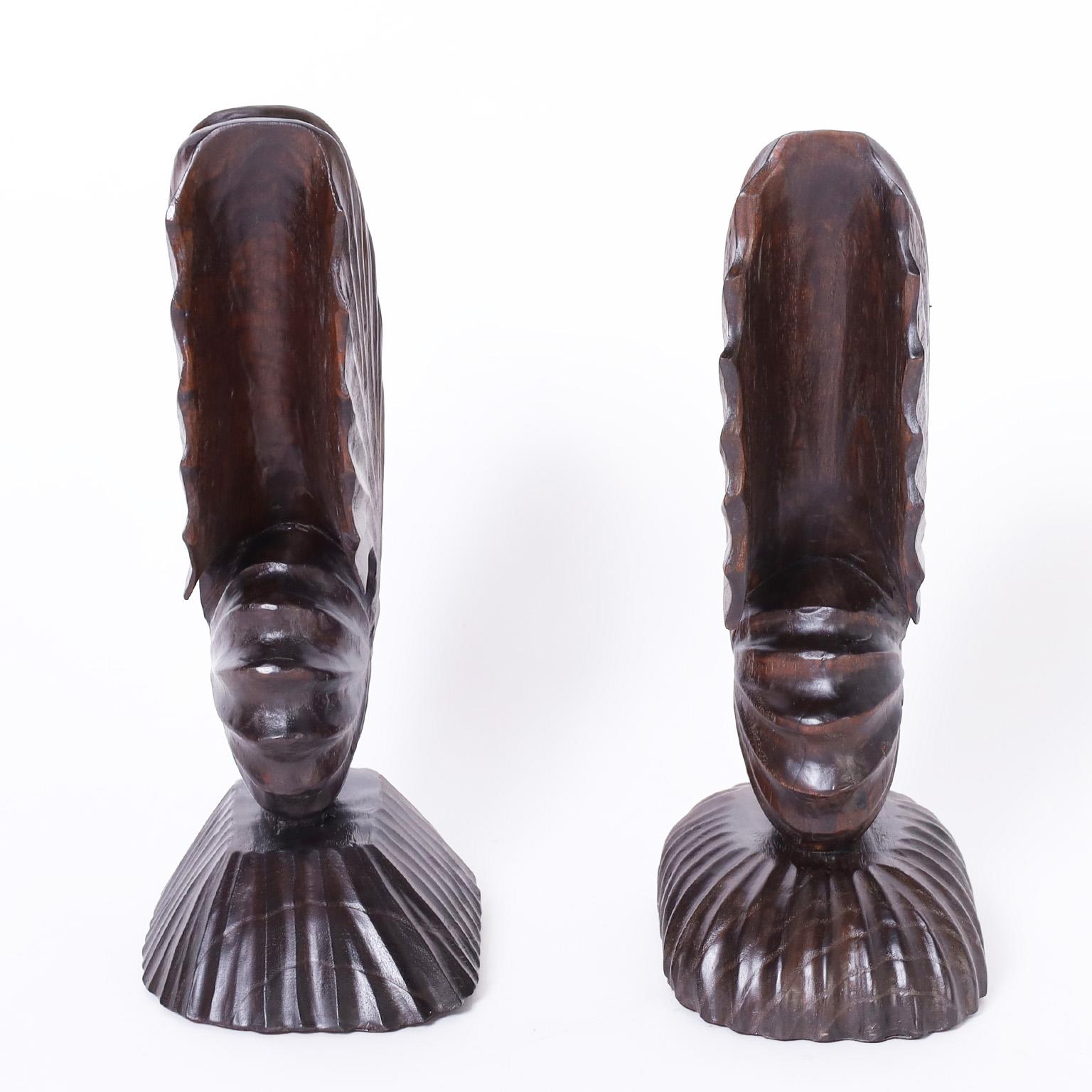 Mid-century nautilus sculptures or objects of art carved from mahogany in a stylized form with a dark lush finish.