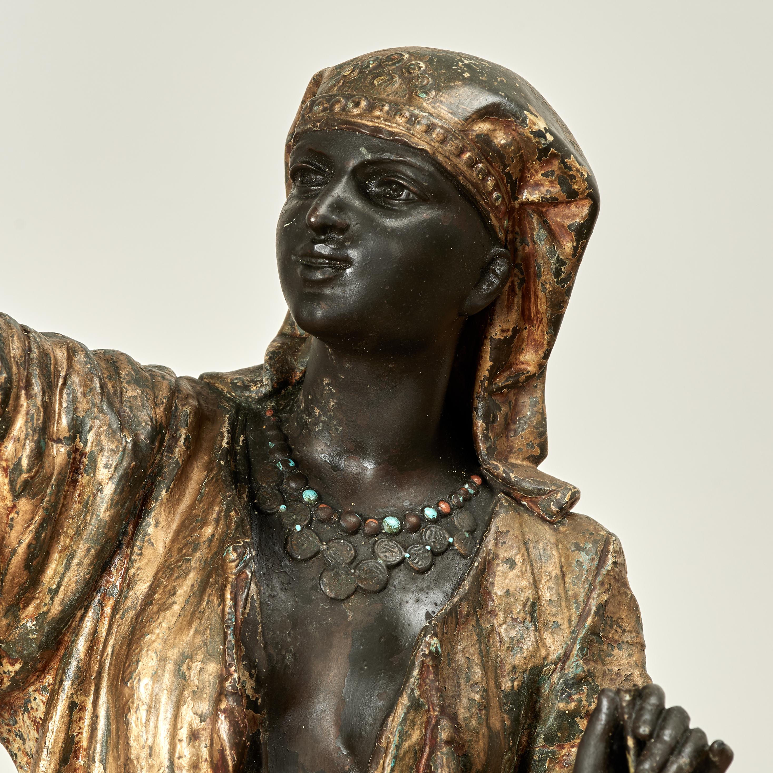 Fine pair of 19th century Austrian bronze figural sculptures, a male and female in classic Bedouin attire and active stance, both cold paint and gilt decorated now with a charming time worn patina. As seen in the listing photos, the original