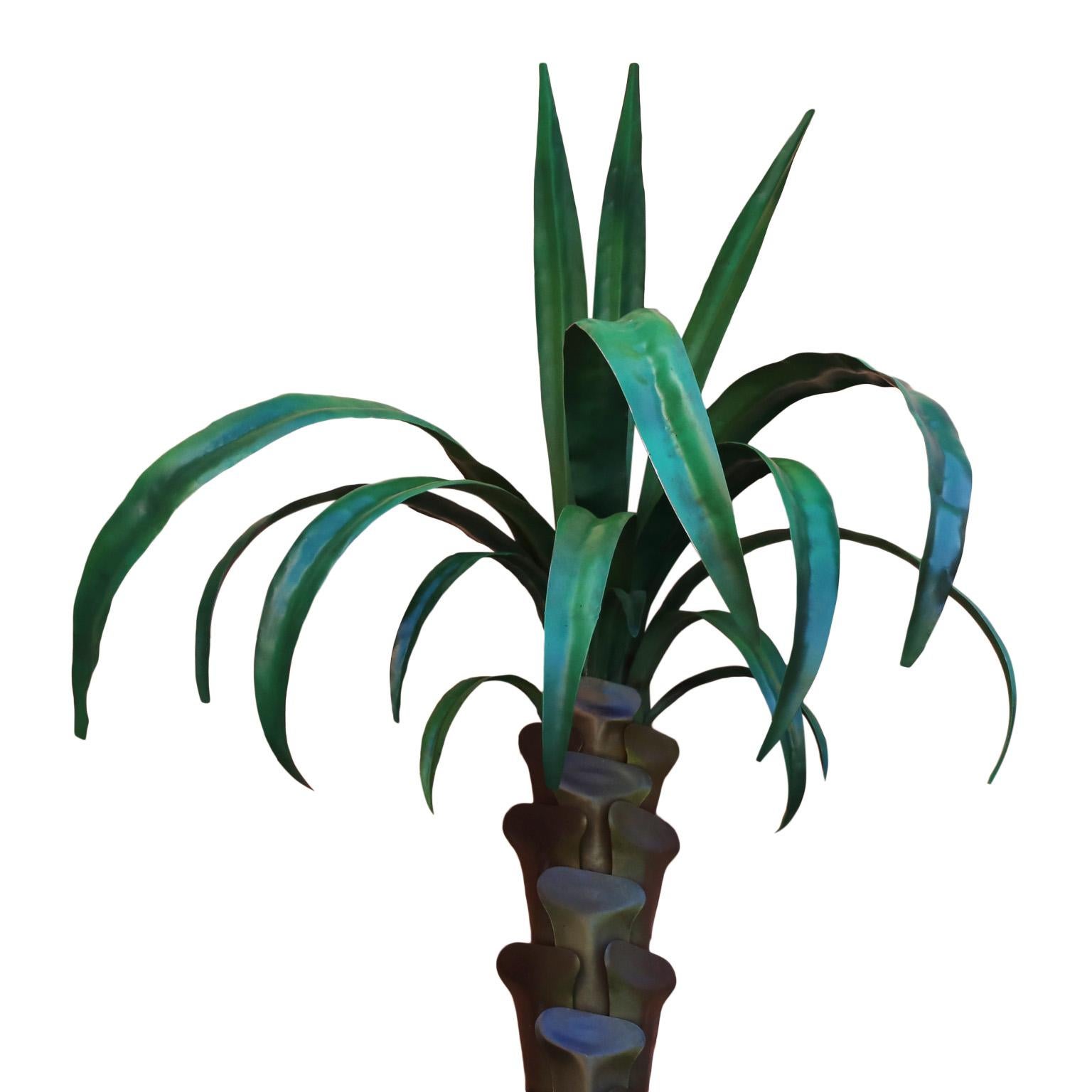 Standout life sized pair of vintage tole or painted metal wall mounted palm tree sculptures with plenty of decorative appeal.