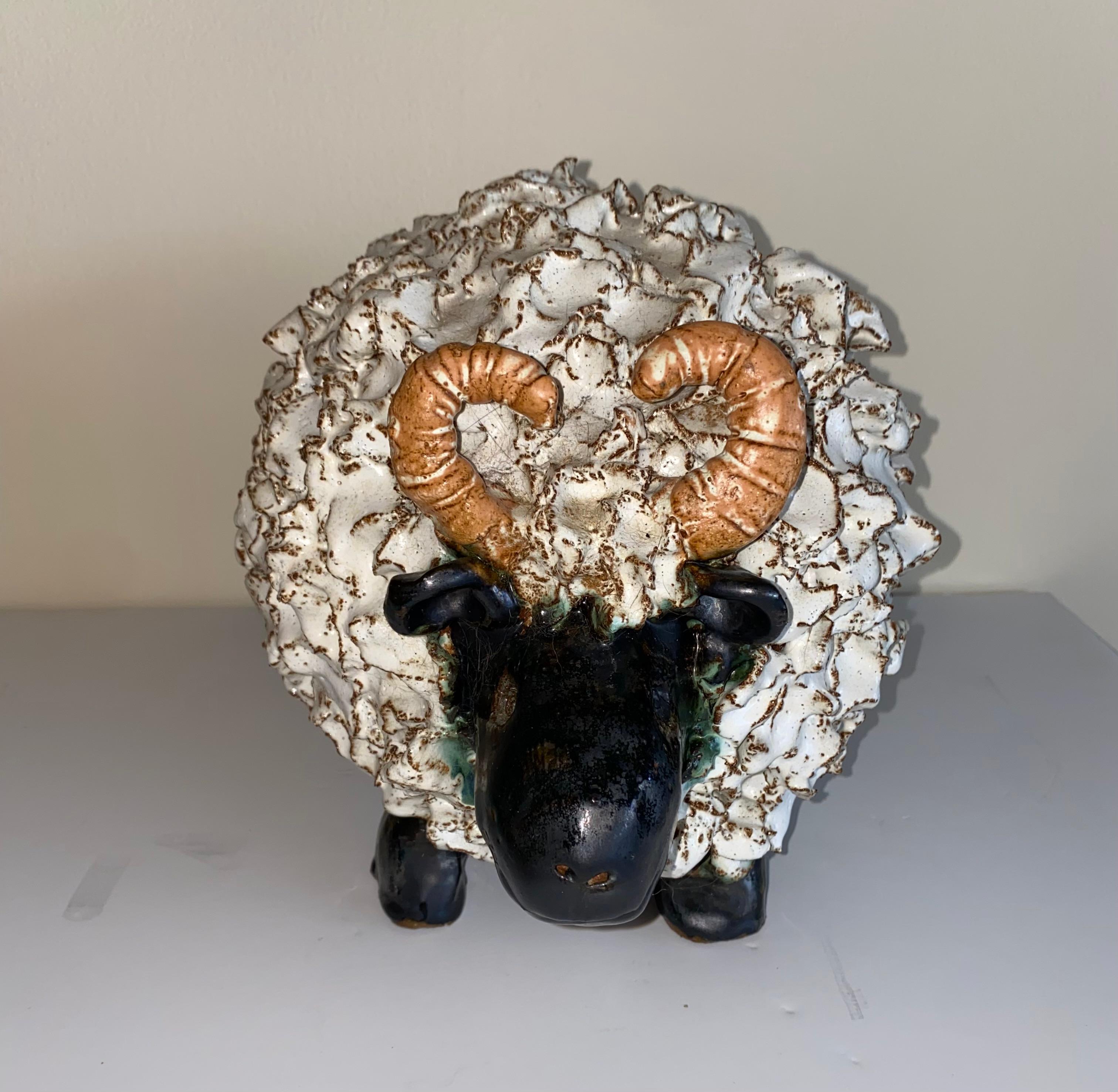 A whimsical pair of glazed terracotta sheep with a textured white and black glaze.
Both are indistinctly signed and the small appears to be dated.
The price listed is for the pair.
Large is 11.5