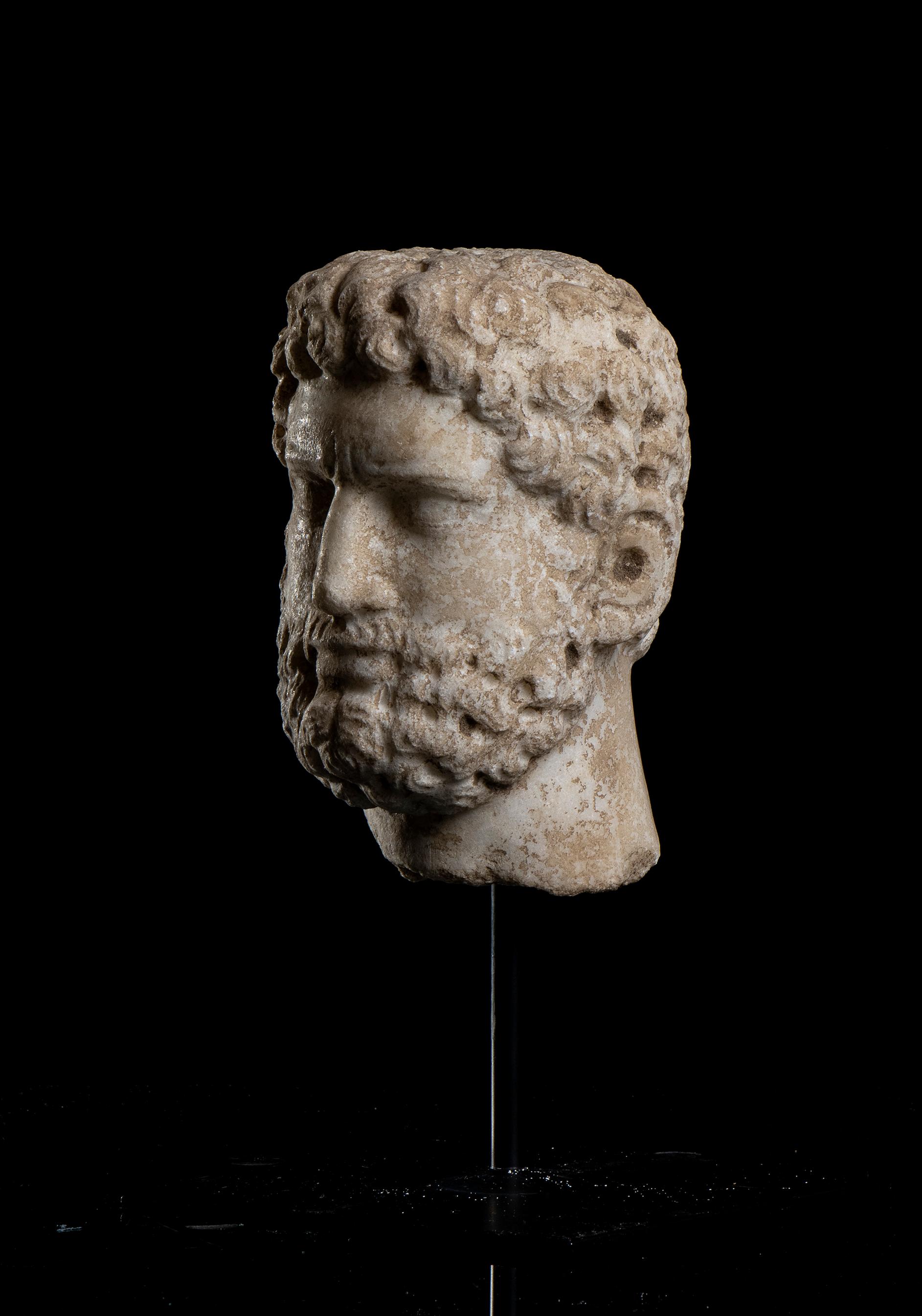 A white marble hand carved head, depicting the portrait of the  Roman Emperor Caracalla, Rome 20th century .
The sculpture standing on a black metal square base with a central pin present a detailed work with an interesting study of detail, clearly