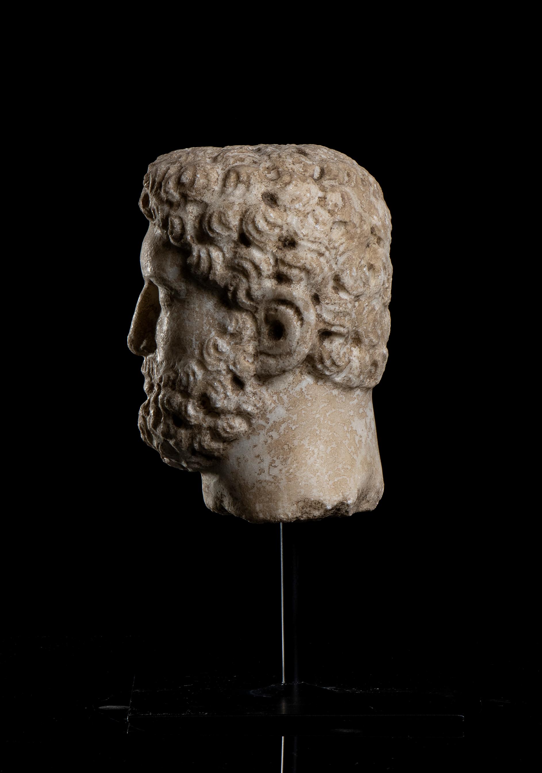 A white marble hand carved head, depicting the portrait of the  Roman Emperor Caracalla, Rome 20th century .
The sculpture standing on a black metal square base with a central pin present a detailed work with an interesting study of detail, clearly