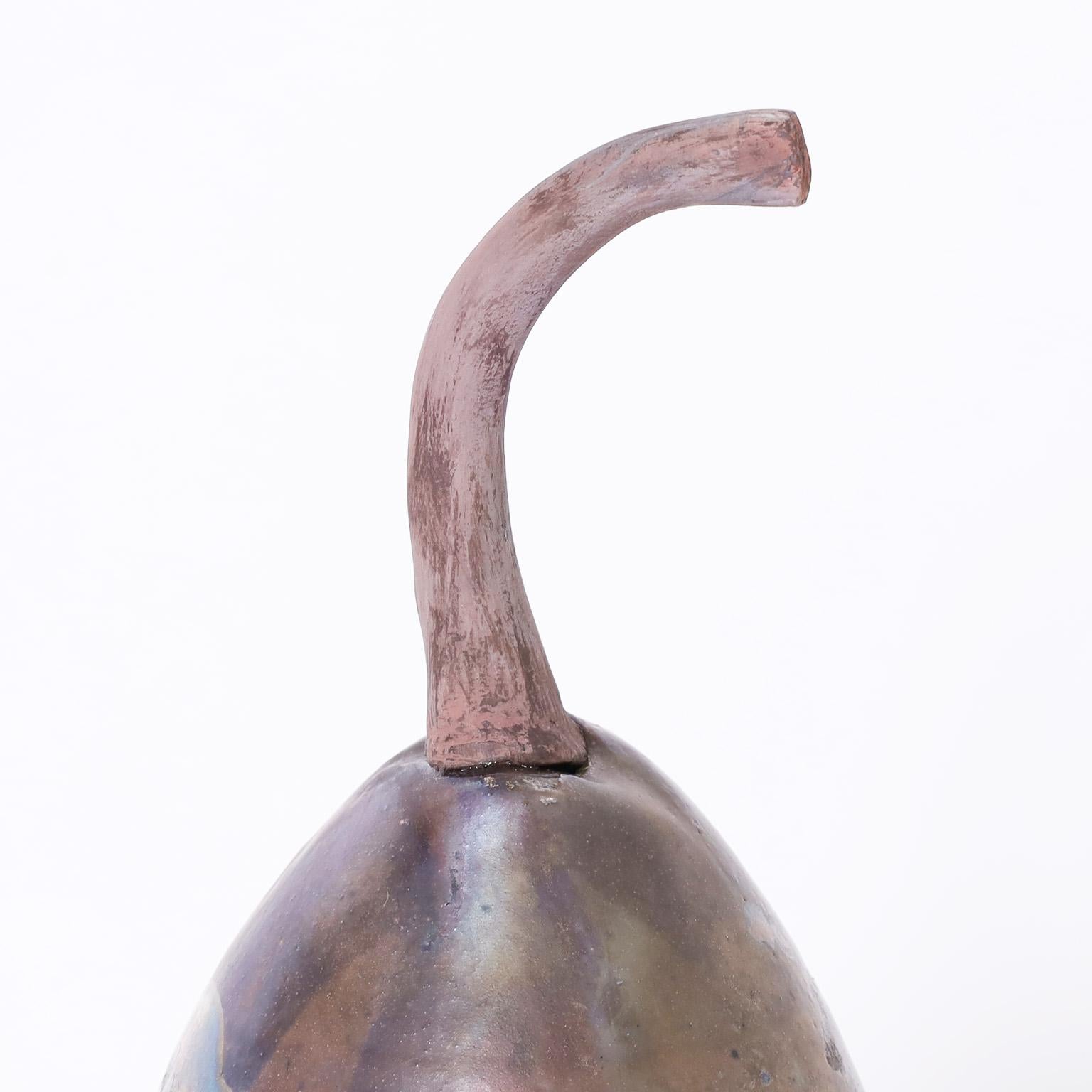 Standout pottery pear sculpture or object of art featuring a distinctive raku style glaze. Signed by noted pottery artist Steven Forbes-deSoule on the bottom.