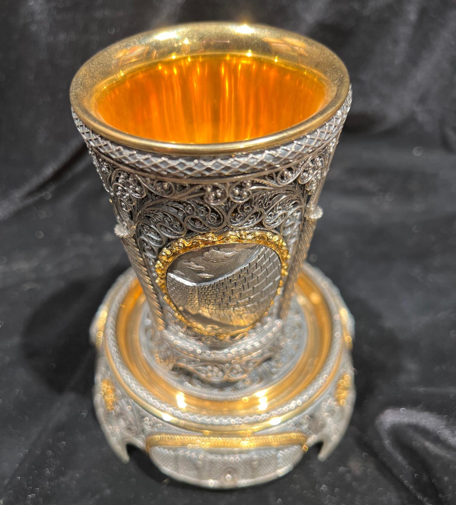 A set of a spectacularly beautiful Kiddush plate and cup. Delicate and precise filigree work. On each side of the cup and the plate appears a holy places in Jerusalem- Rachel's tomb, the Western Wall and the Tower of David.
A combination of gold and